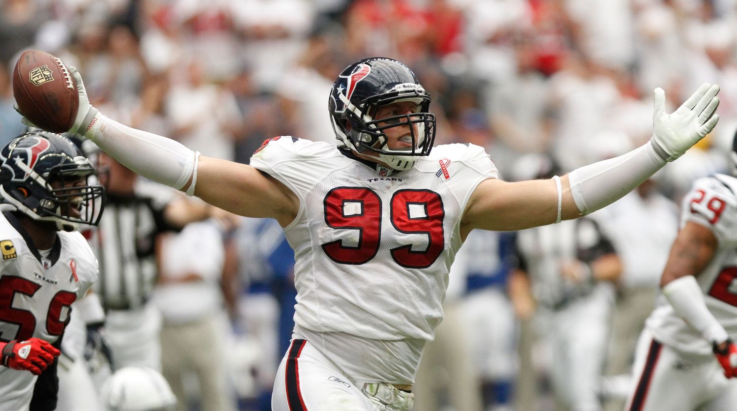 Football players celebrate with arms raised during a game.