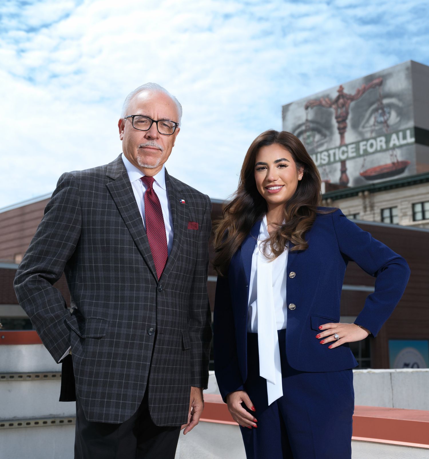 Business portrait session against urban backdrop with blue sky and architectural elements.