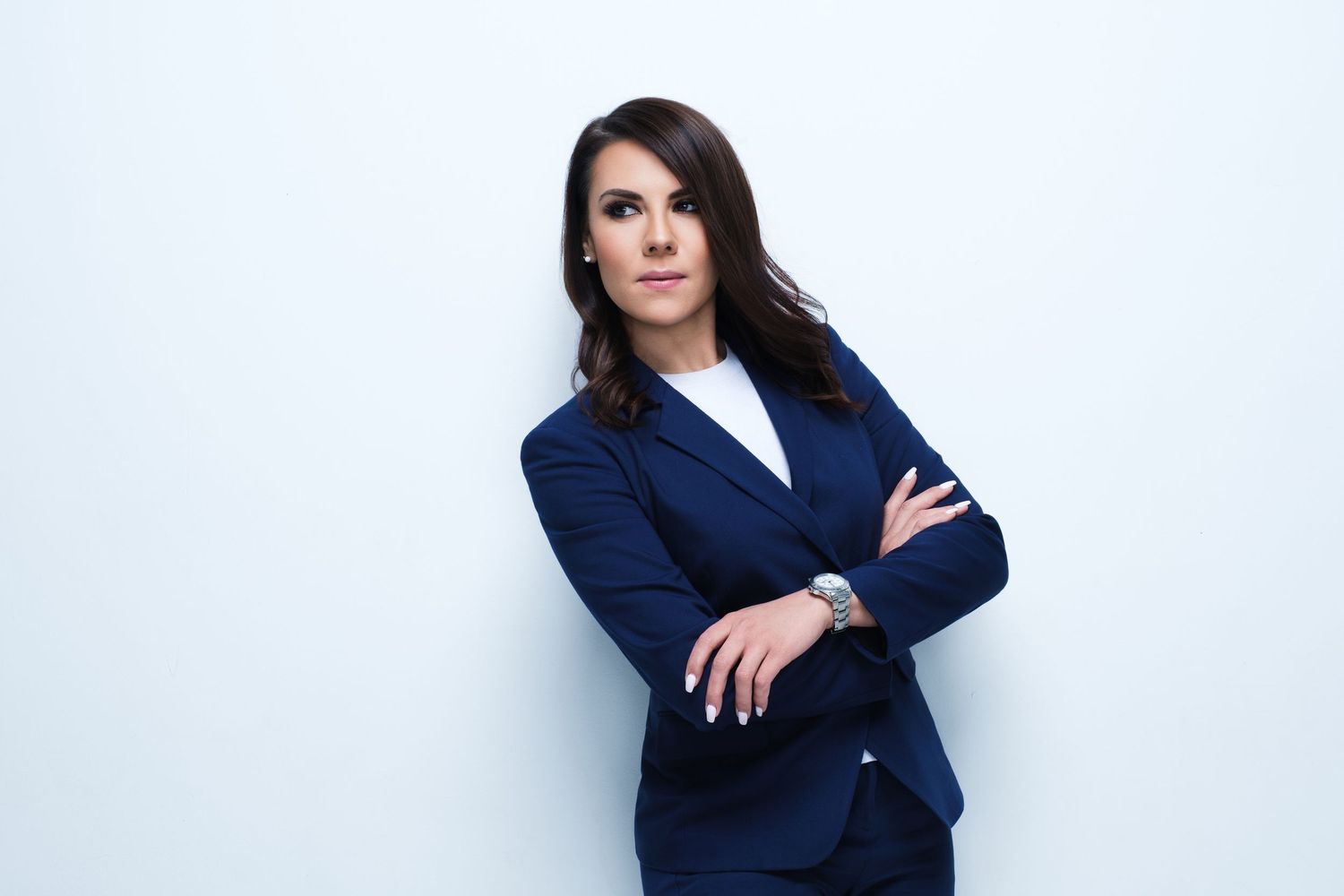Series of professional poses showing someone in navy blazer against white background.