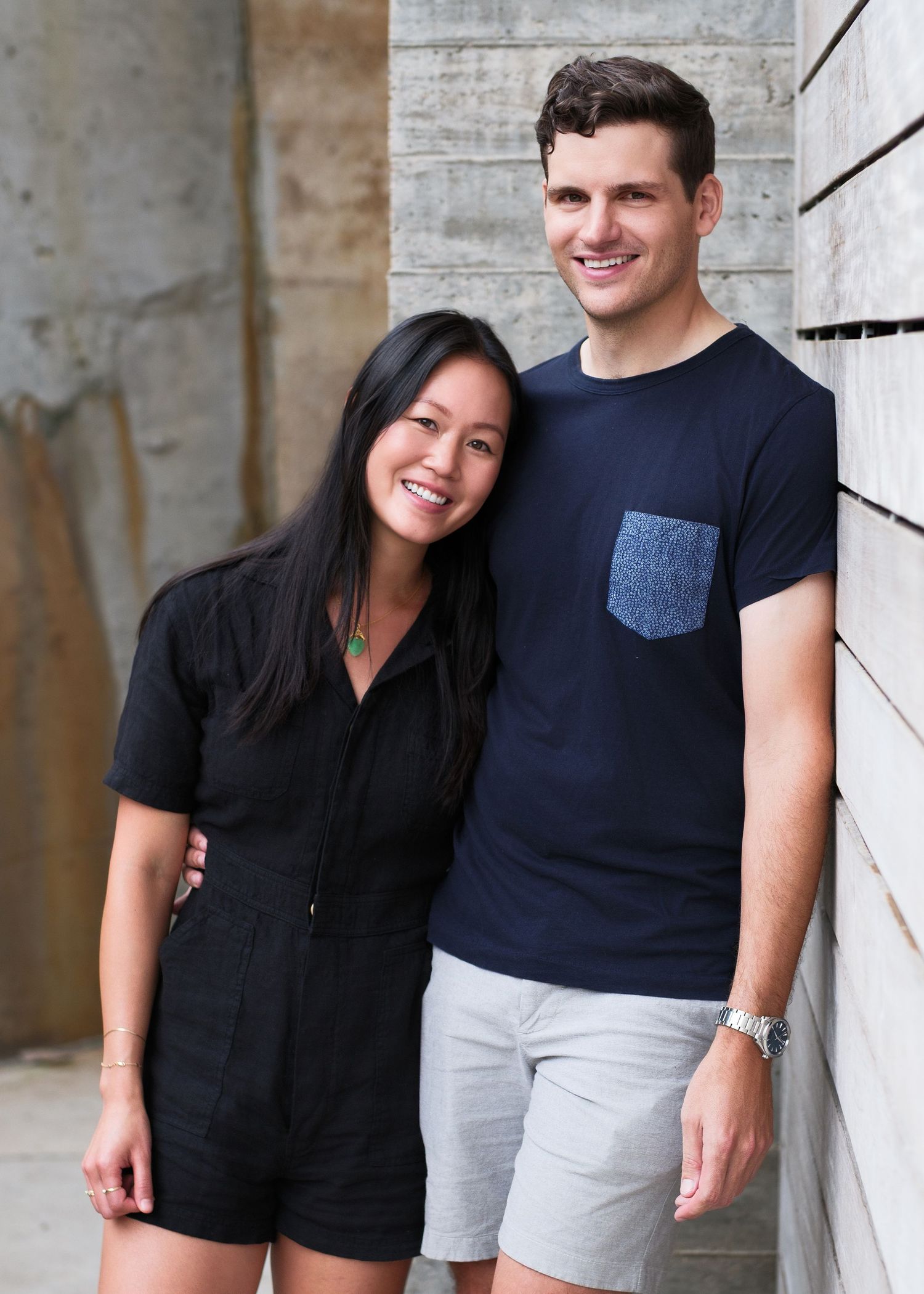 Casual outdoor photoshoot against concrete wall background.
