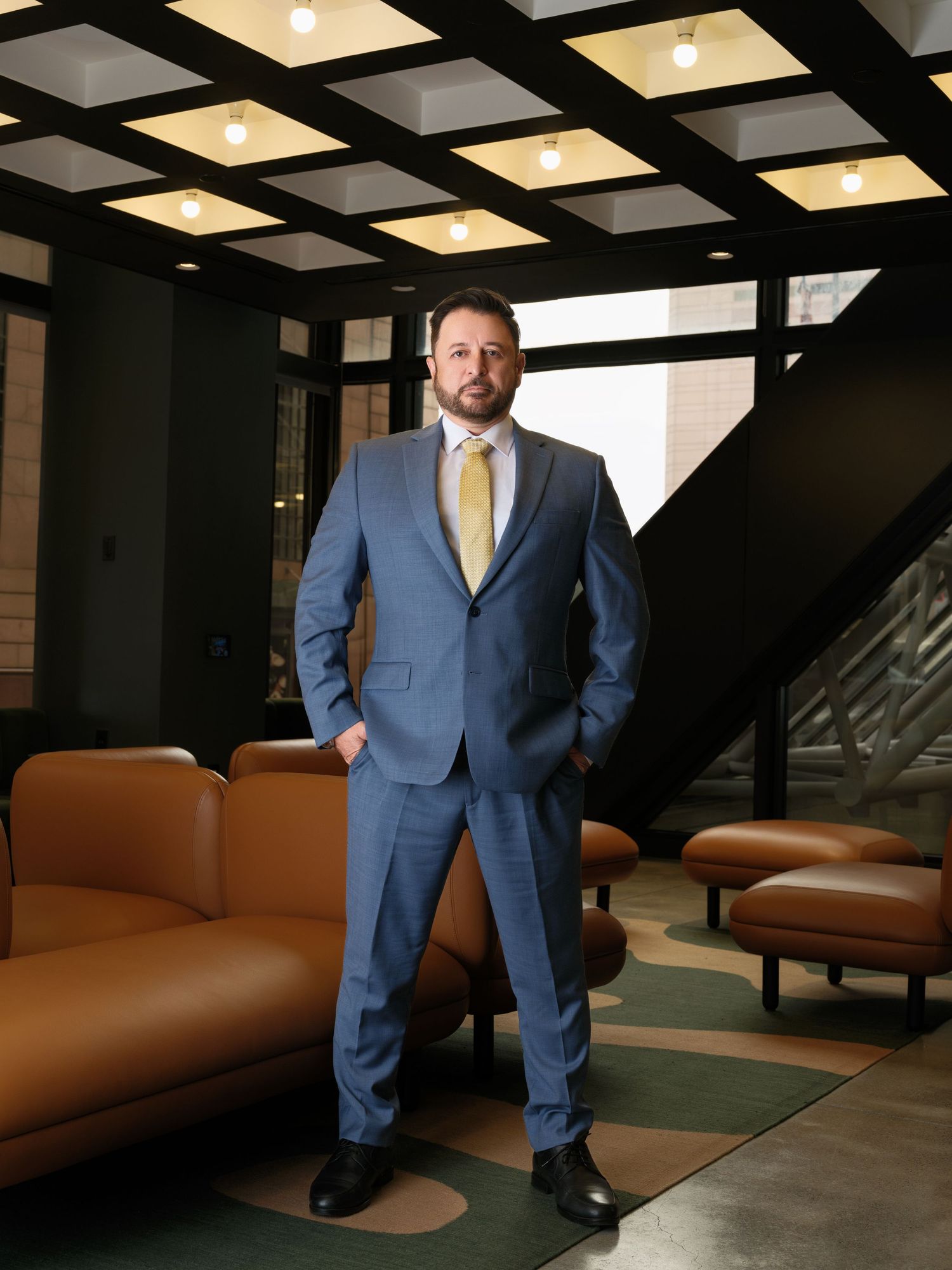 Modern office interior photoshoot featuring leather seating and architectural lighting.