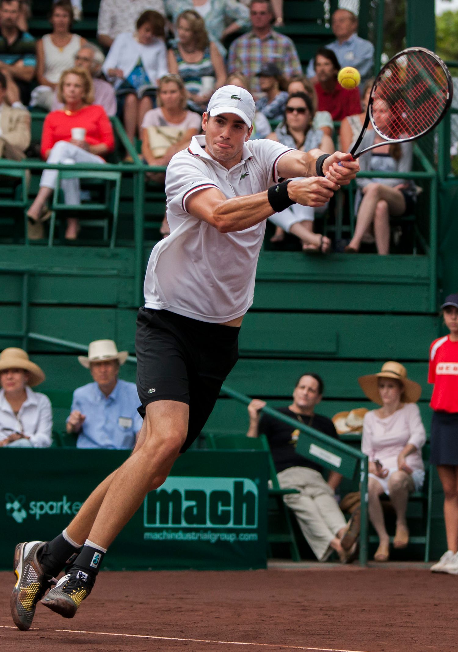 Tennis players stretch and lunge for shots during an intense match on a clay court.