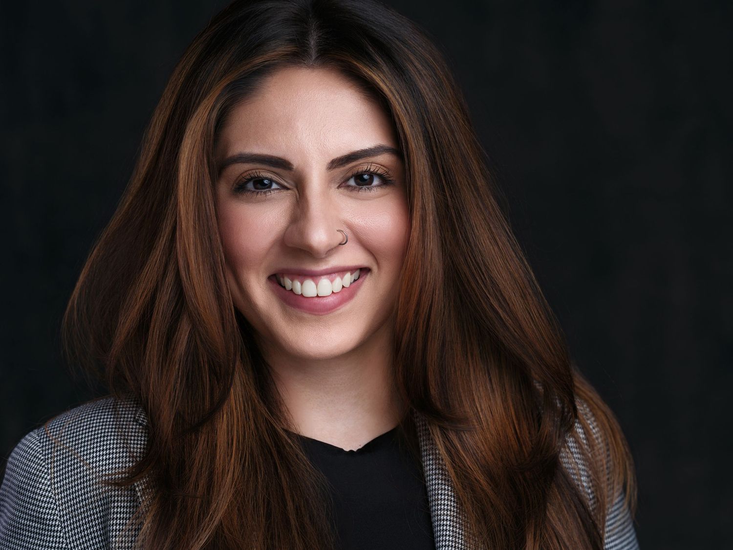 A series of six headshots against a dark background showing different expressions and poses.