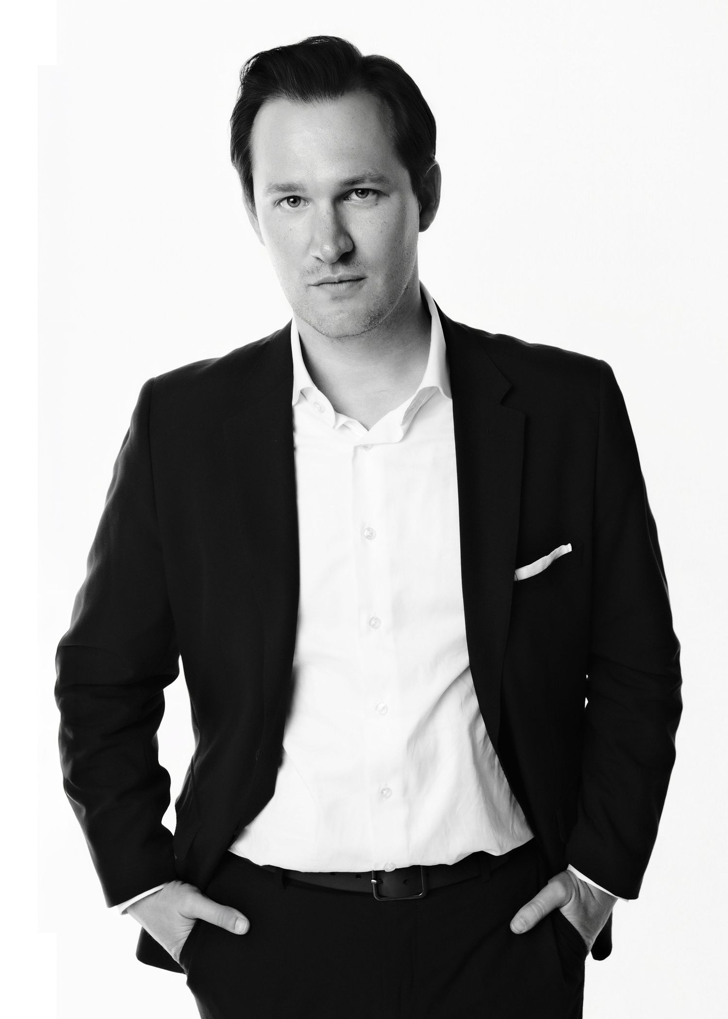 Professional black and white portrait series showing different poses in business attire.