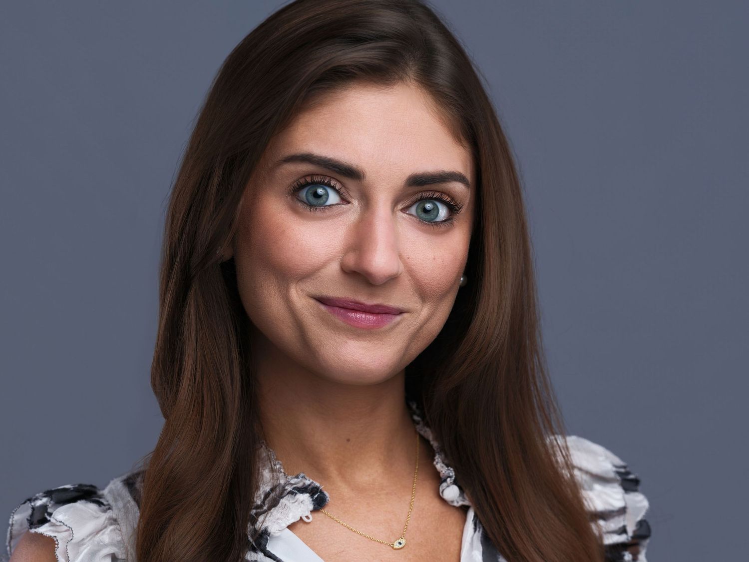 Series of professional portraits showing someone in a white blouse and dark blazer against a blue backdrop.