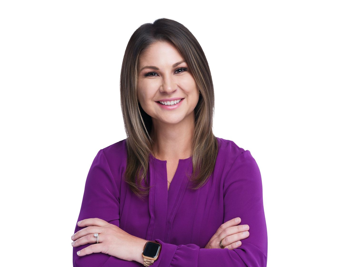 Confident professional wearing purple blouse with smartwatch against white background.