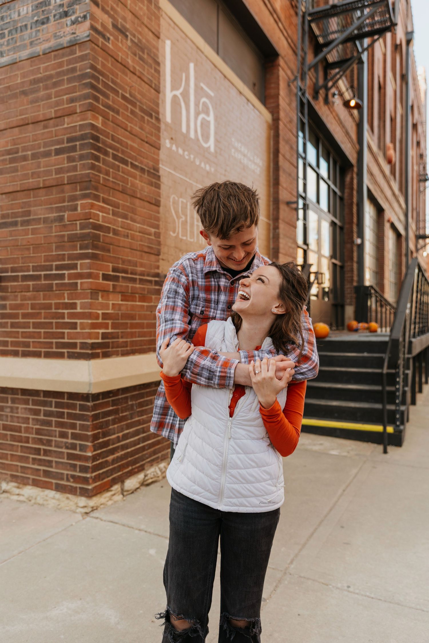Couple laughing together during a playful engagement session
