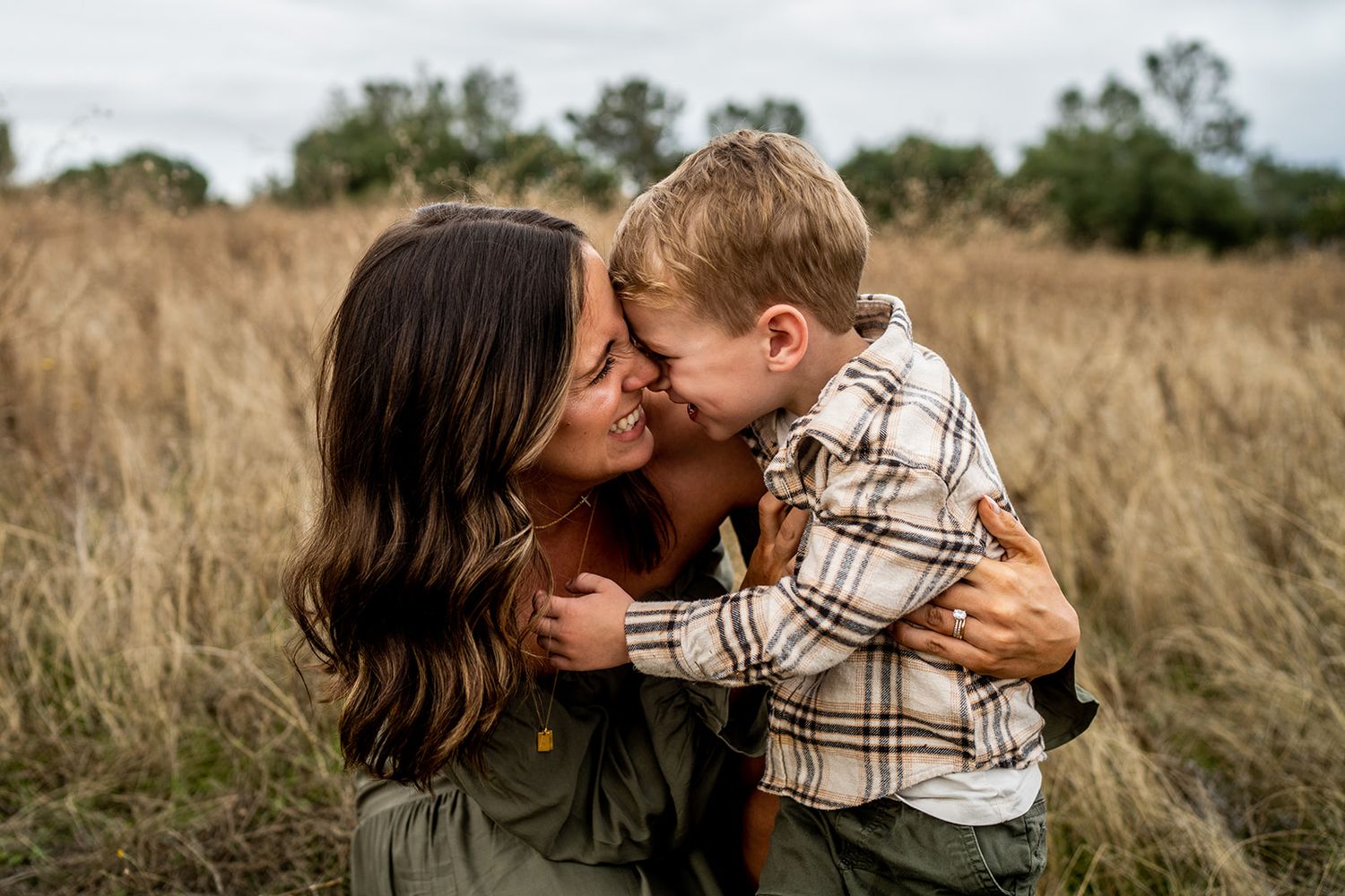 Series of intimate family moments captured in a rustic field setting.