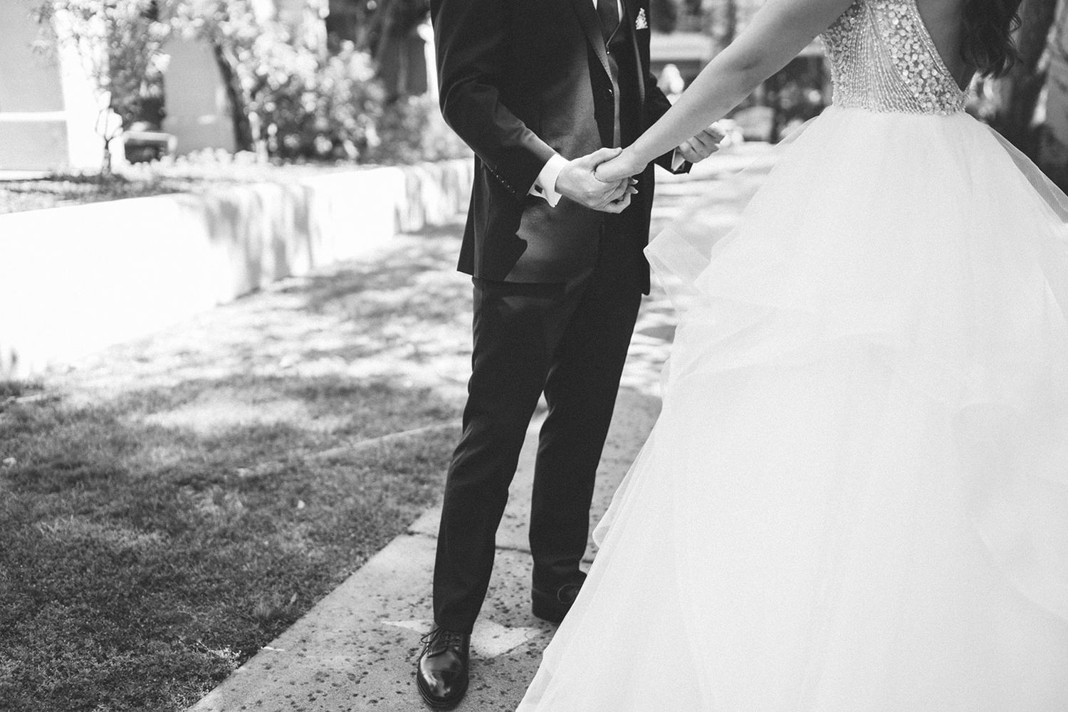 Black and white wedding photos showing candid moments and dress details.