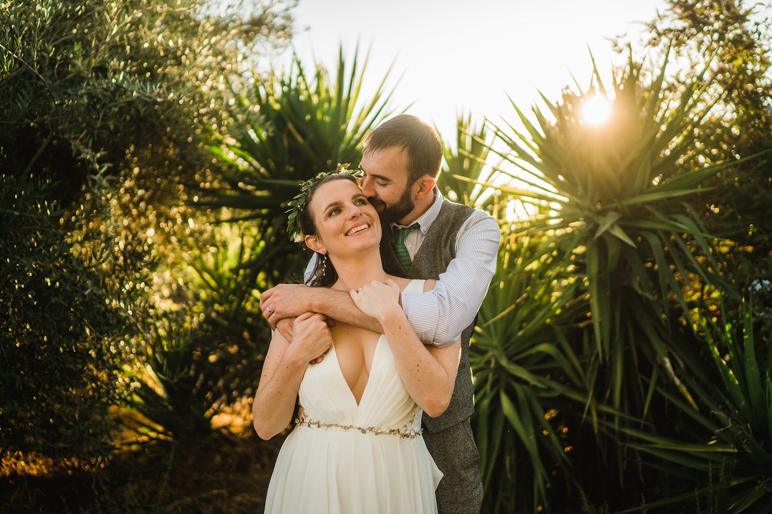 Romantic sunset photo session in a tropical garden setting with palm trees.
