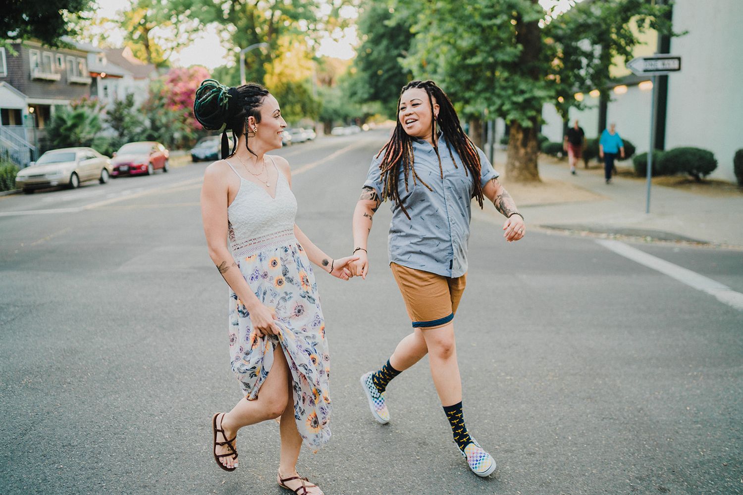 Happy friends jumping and playing together on an urban street.