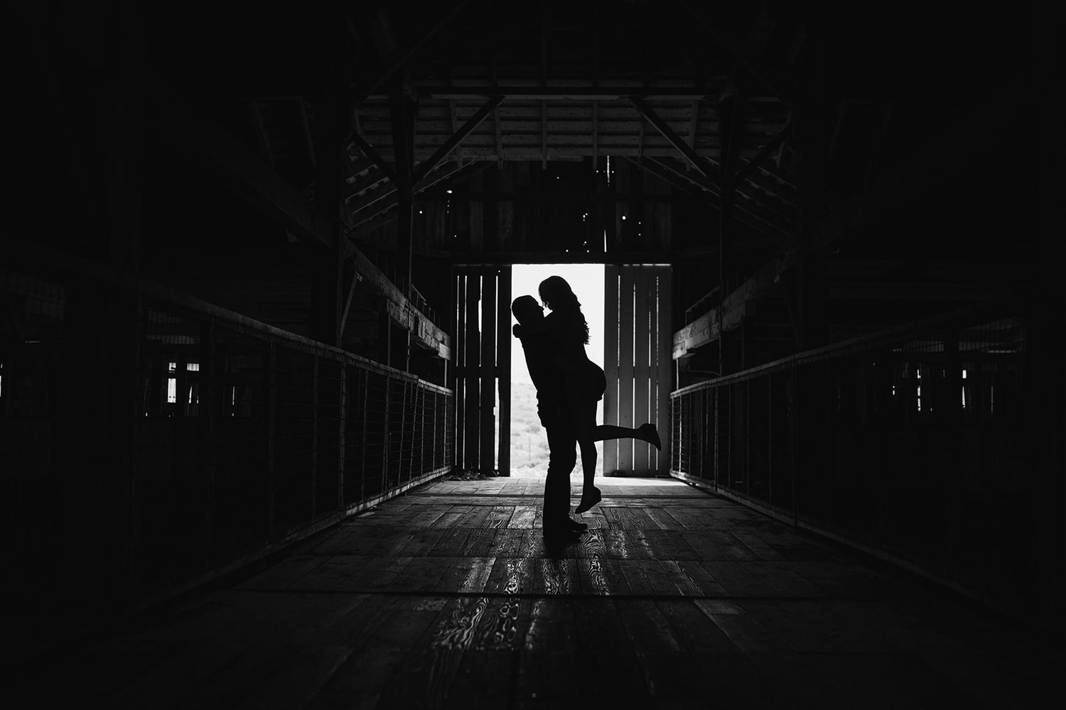 A silhouetted figure stands in a dark tunnel with light at the end.