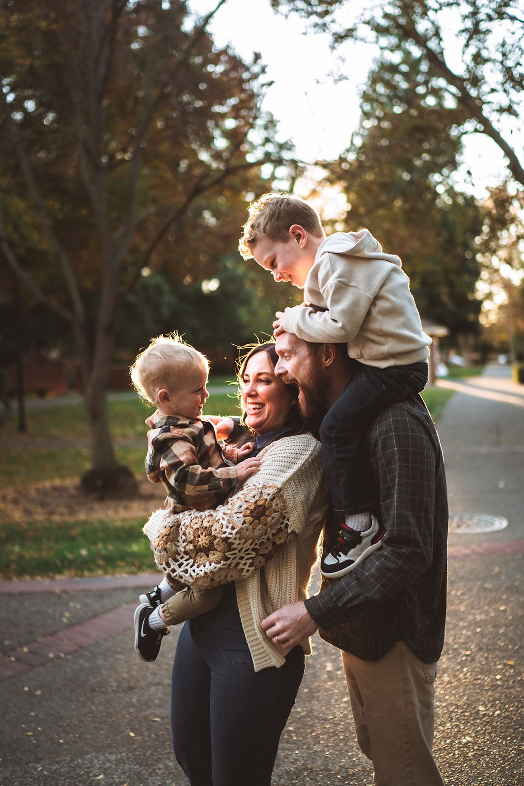 A sweet family moment captured in a series of playful interactions outdoors during golden hour.