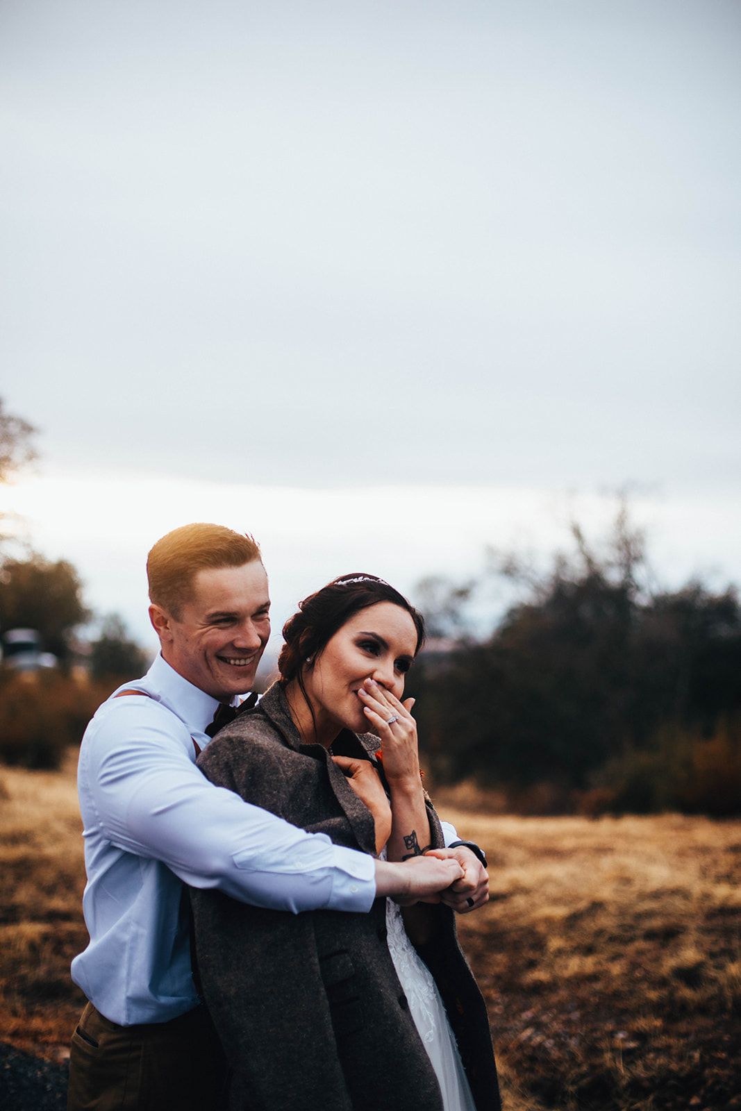 Couple sharing intimate moments during a sunset outdoor photo session.