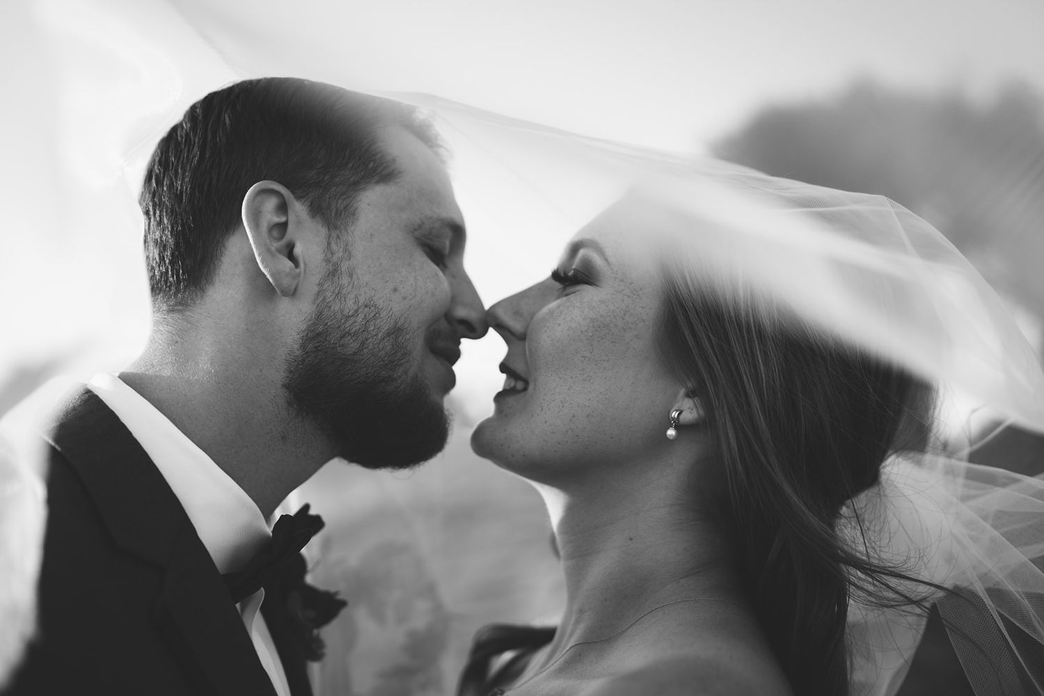 Intimate black and white portrait series of couple sharing tender moments.