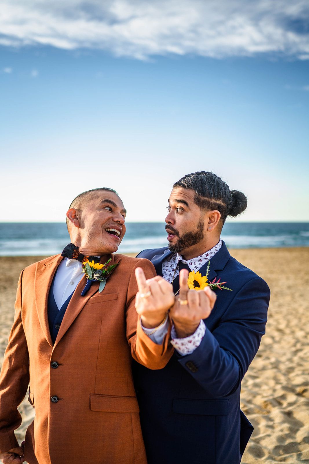Playful beach wedding photos with couples in formal attire against ocean backdrop.
