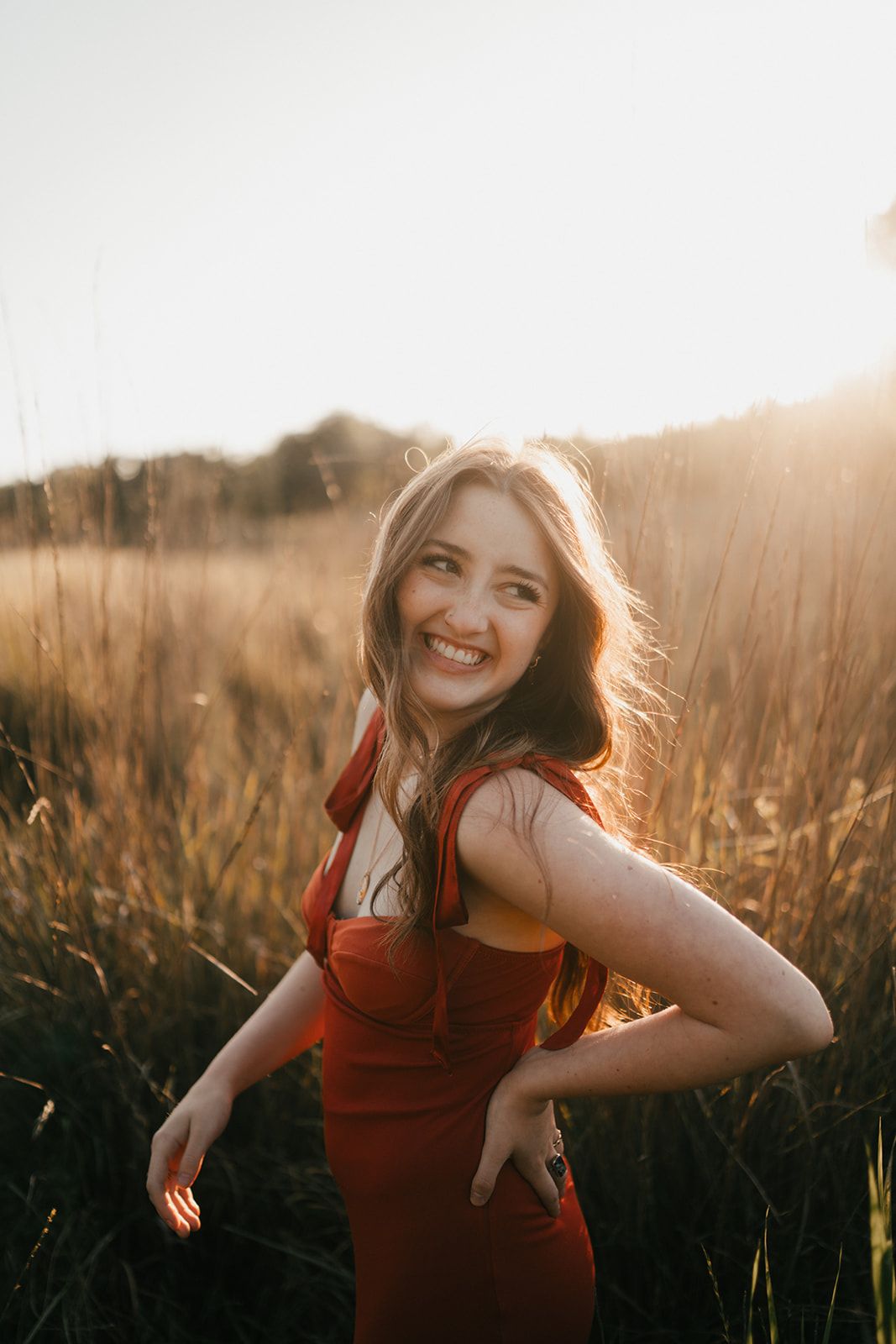 Sun-drenched portrait session in a golden field during magic hour.