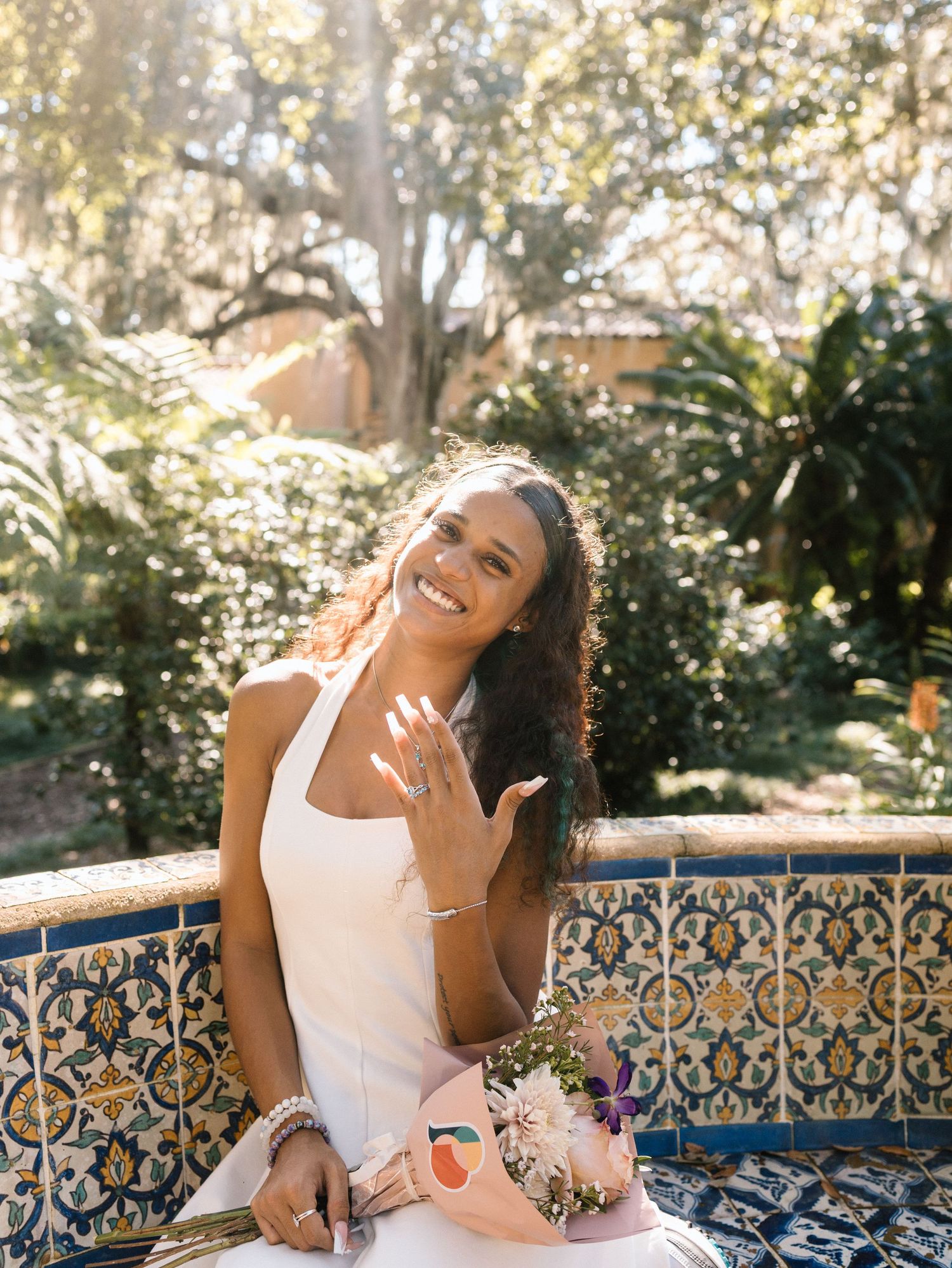 A joyful moment captured on decorative tile steps in a sunny garden setting.