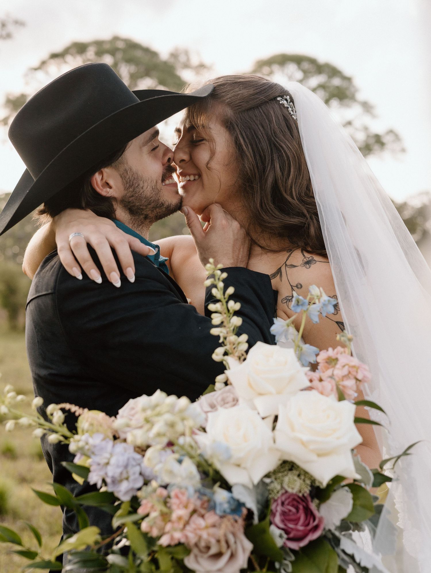 A series of romantic wedding photos showing tender moments between a couple in a rustic outdoor setting with floral bouquets.
