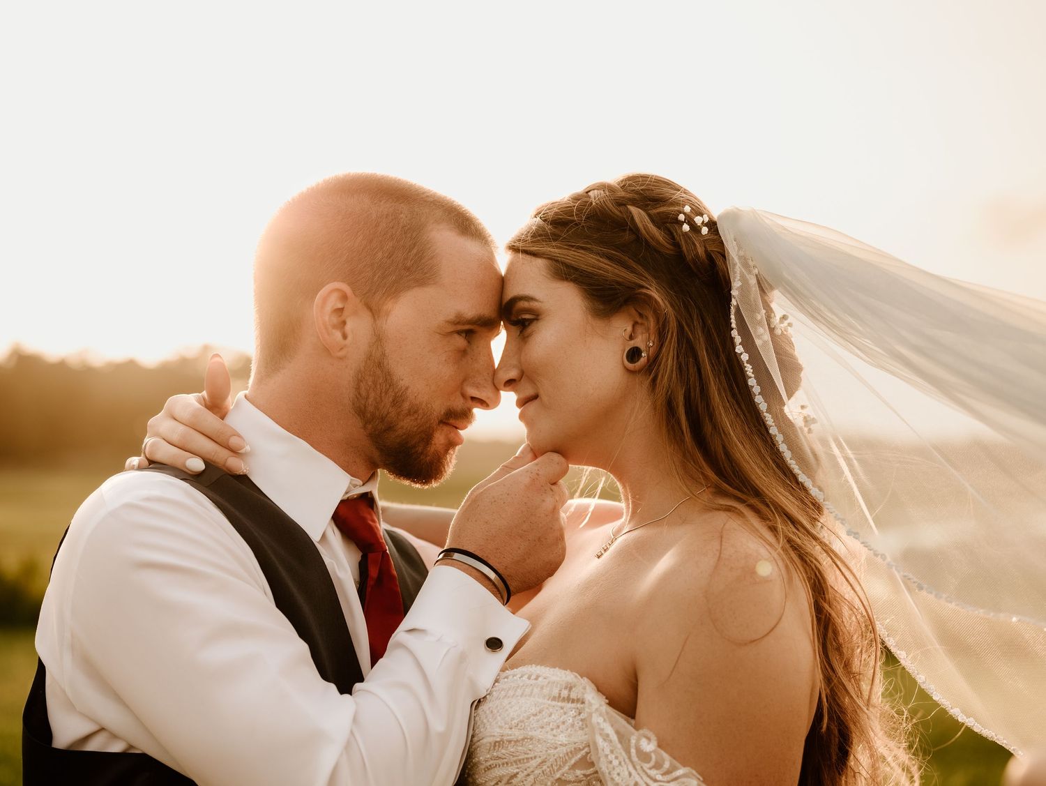 A couple in wedding attire share romantic moments during golden hour in a series of candid outdoor shots.