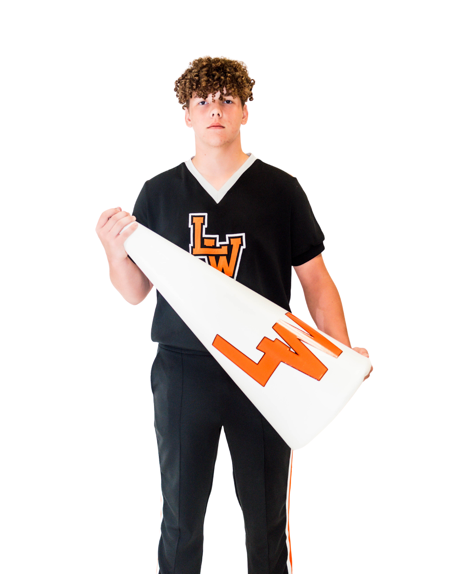 Person in black cheer uniform with orange accents holds white megaphone while standing against white background.