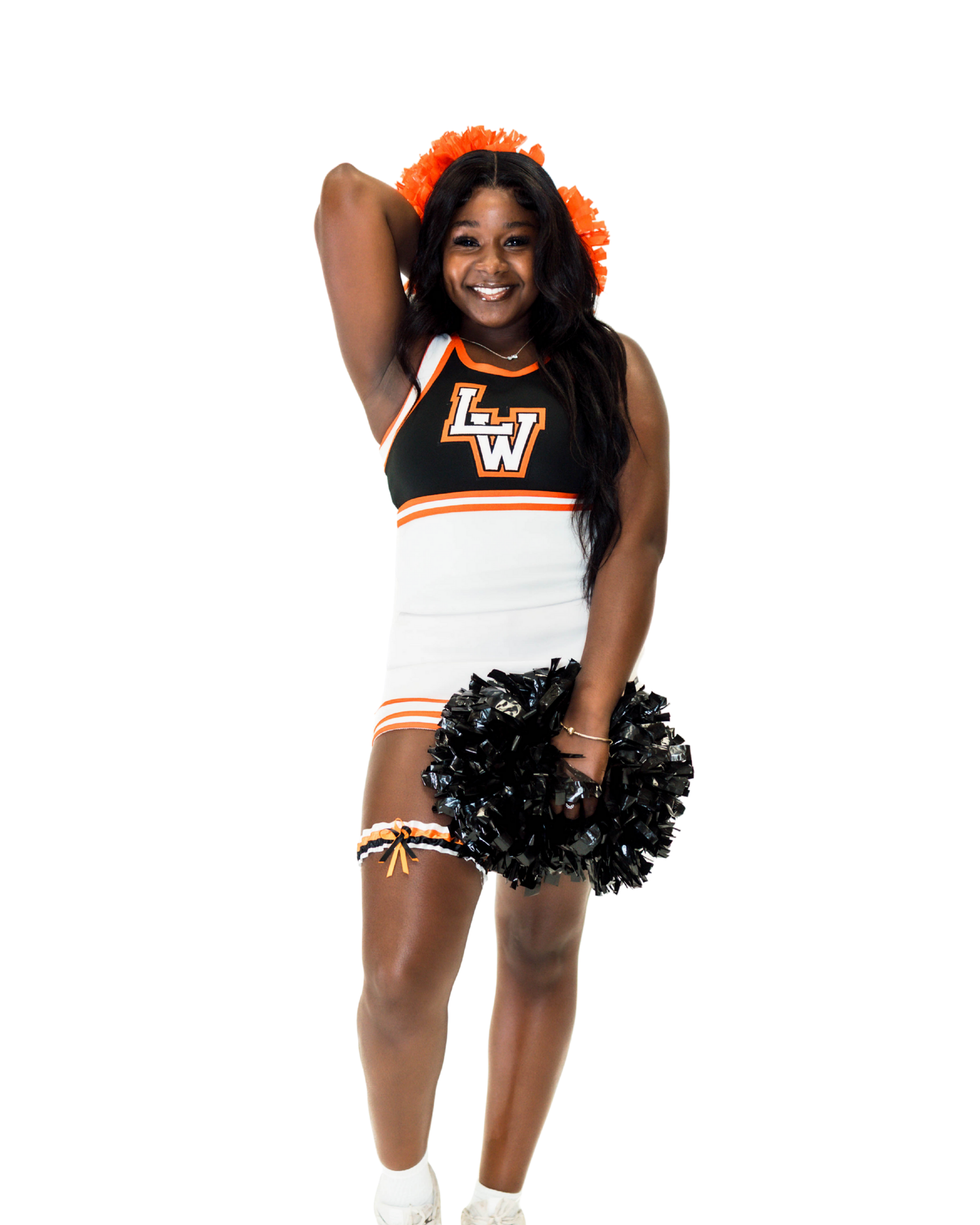 Cheerleader in black, white and orange uniform with pom-poms poses energetically against a white background.