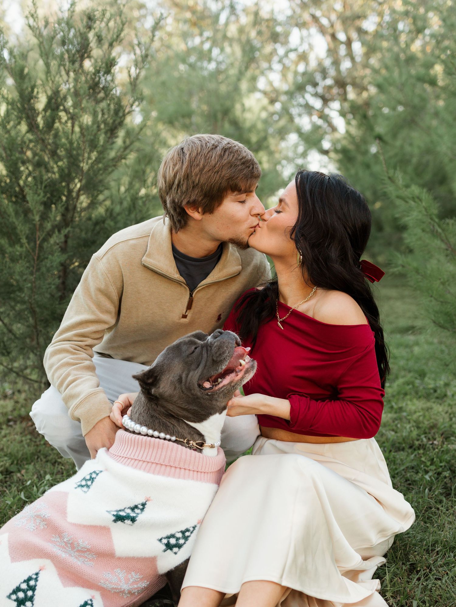 Couple sharing intimate moment with holiday blanket in outdoor winter setting.