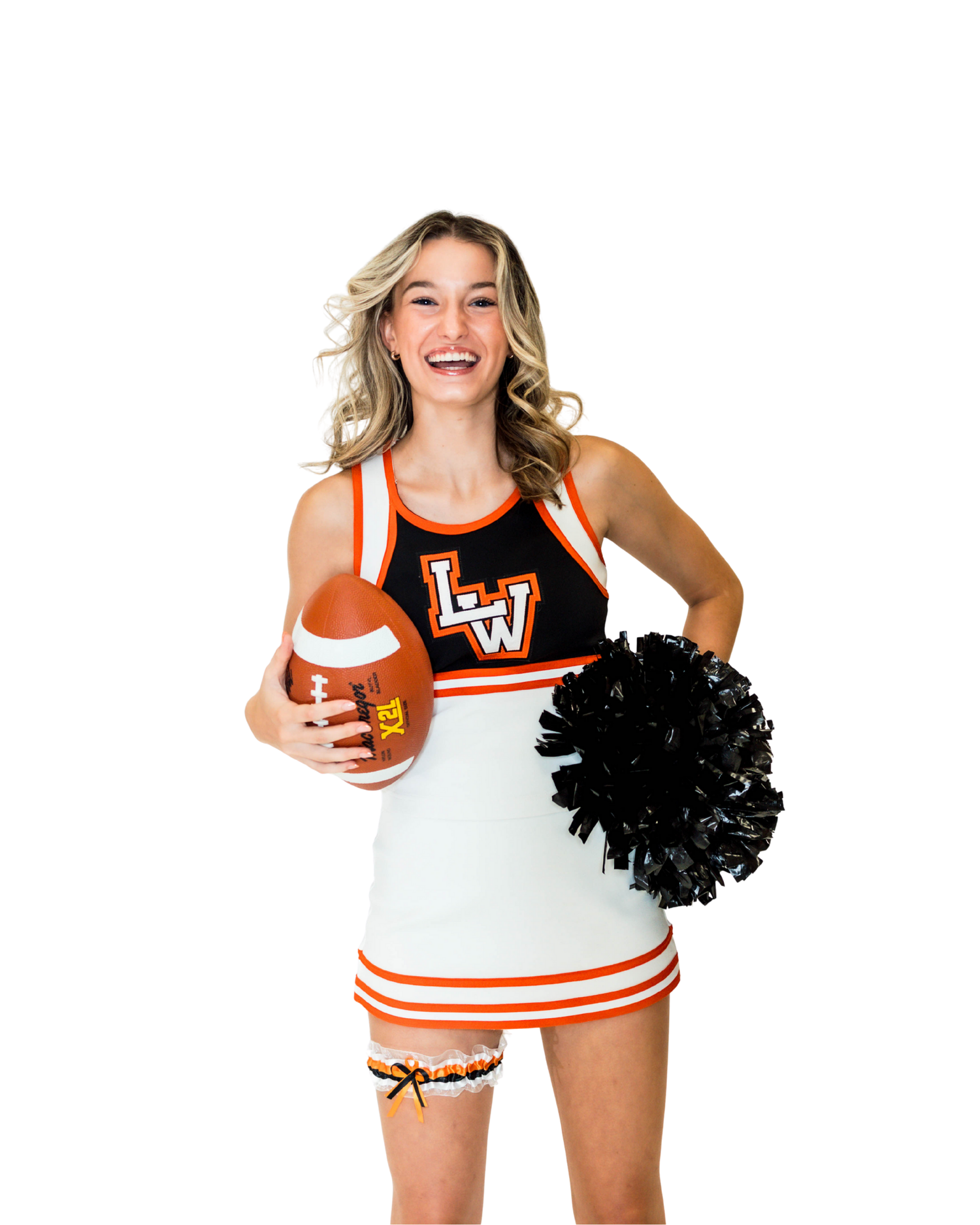 Cheerleader poses with pom poms wearing white and orange uniform set in athletic stance during sports performance.