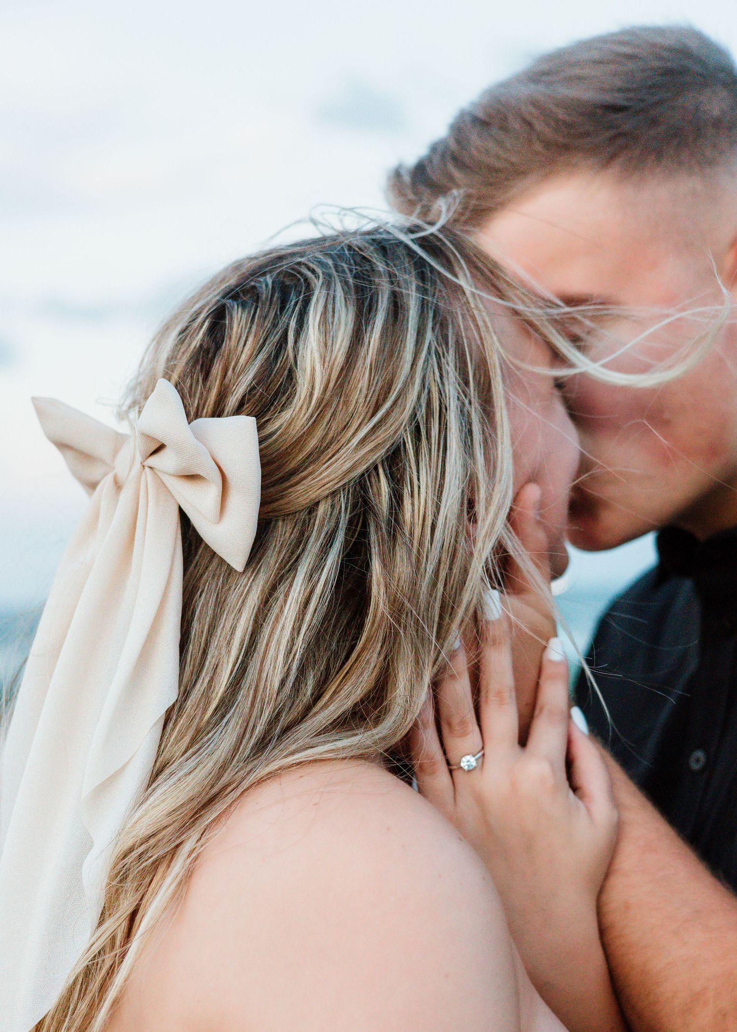 Romantic wedding photos capturing intimate moments between newlyweds with a flowing veil.