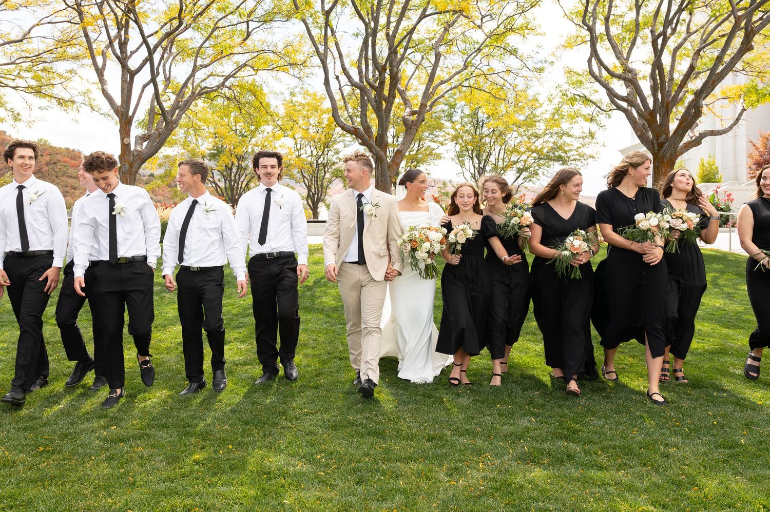 A bride and groom walking with their wedding party