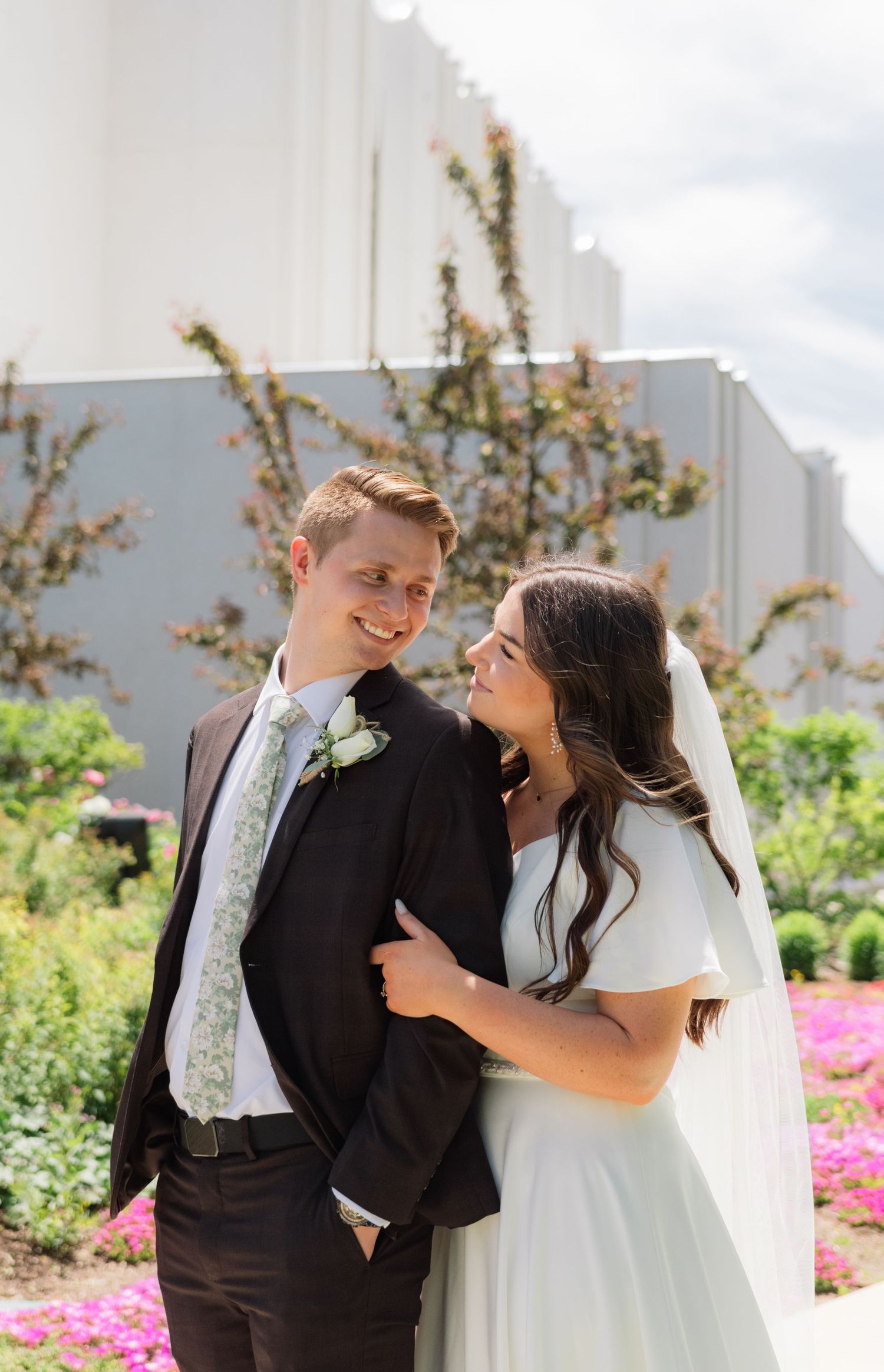 A bride and groom smiling at each other