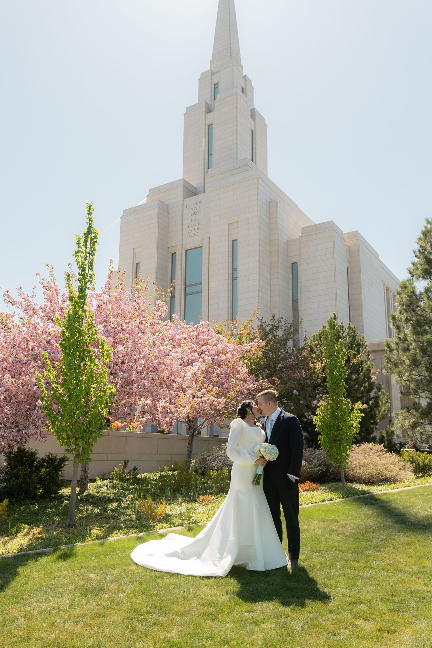A bride and groom outside the Oquirrh Mountain Utah Temple