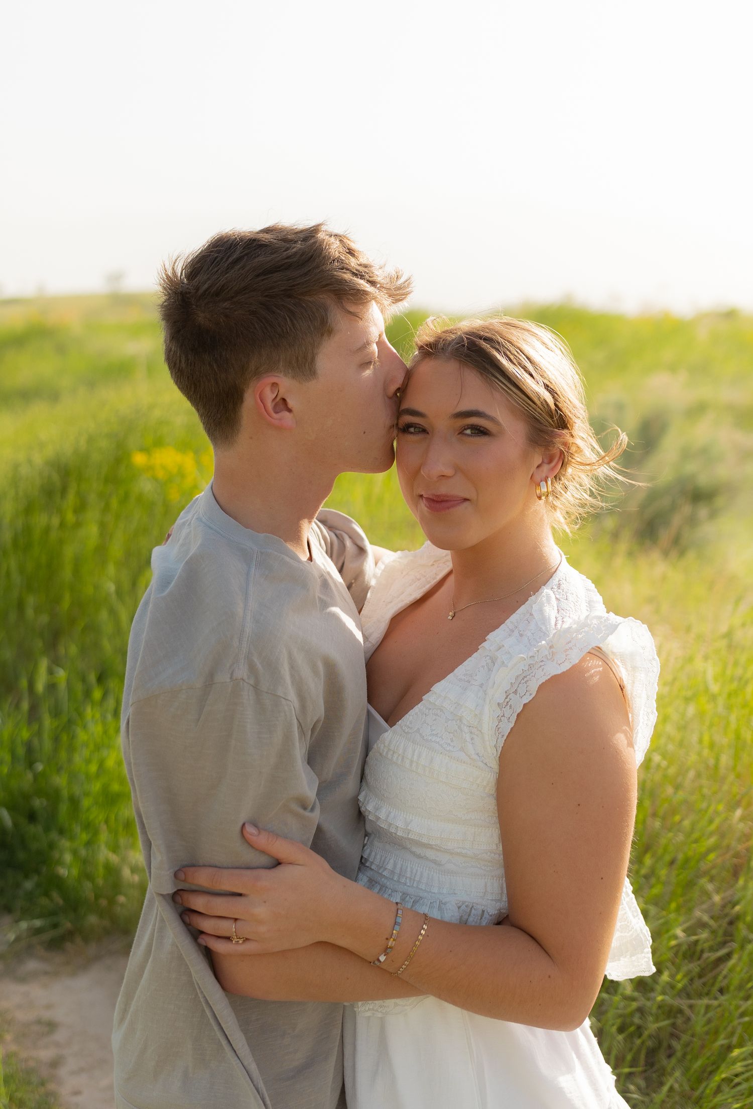 A couple standing together in a green field