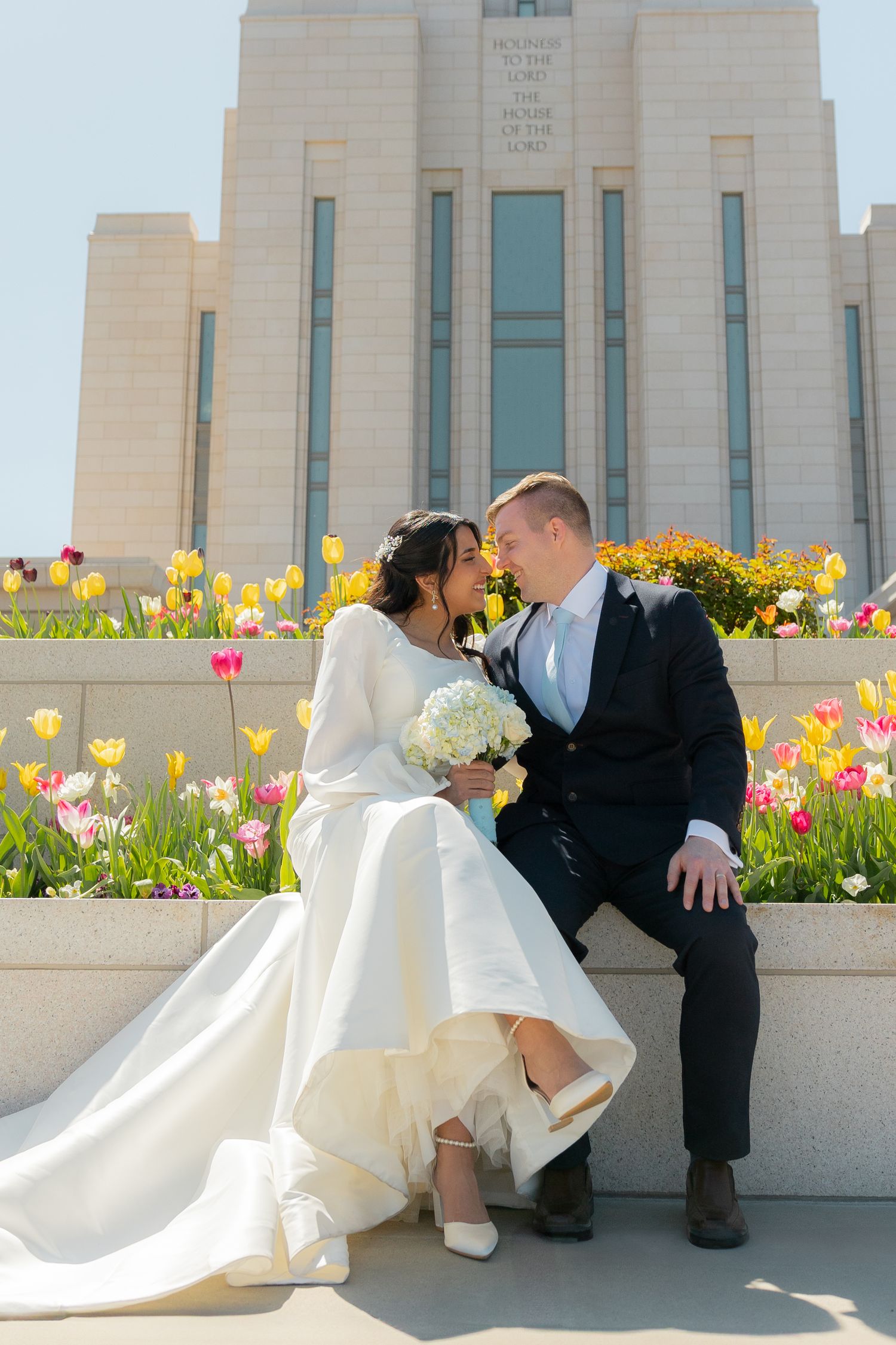 A bride and groom outside the Oquirrh Mountain Utah Temple