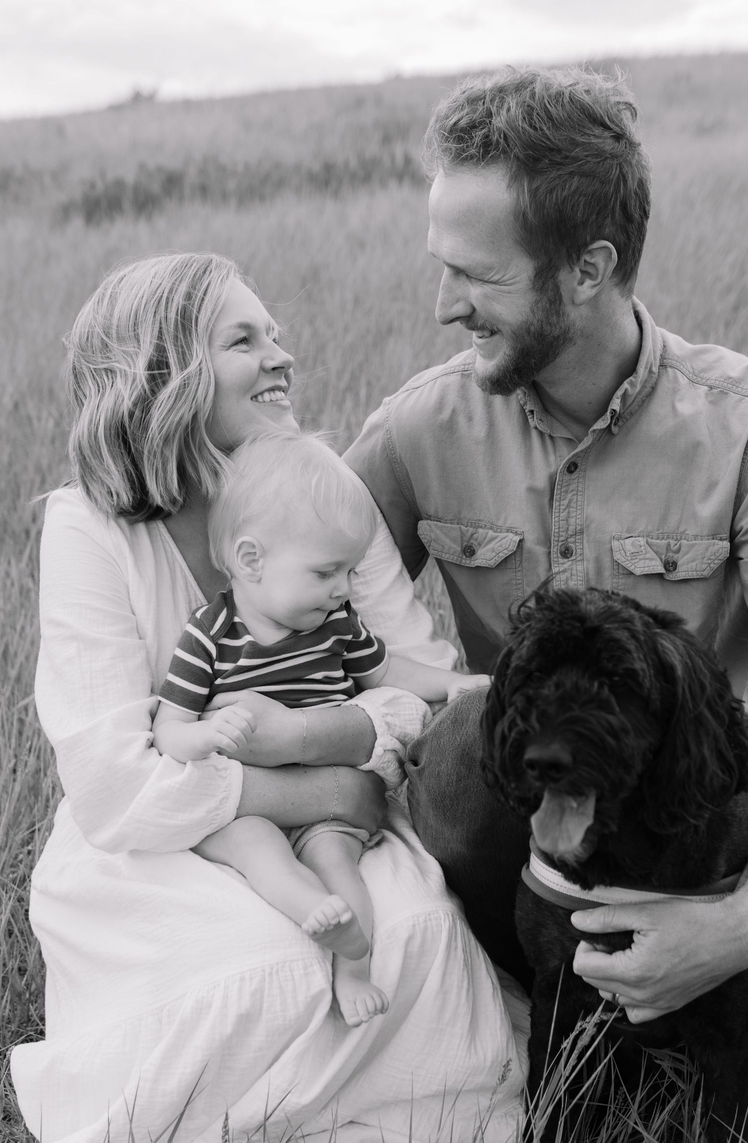 Family photo with one son on a green hill