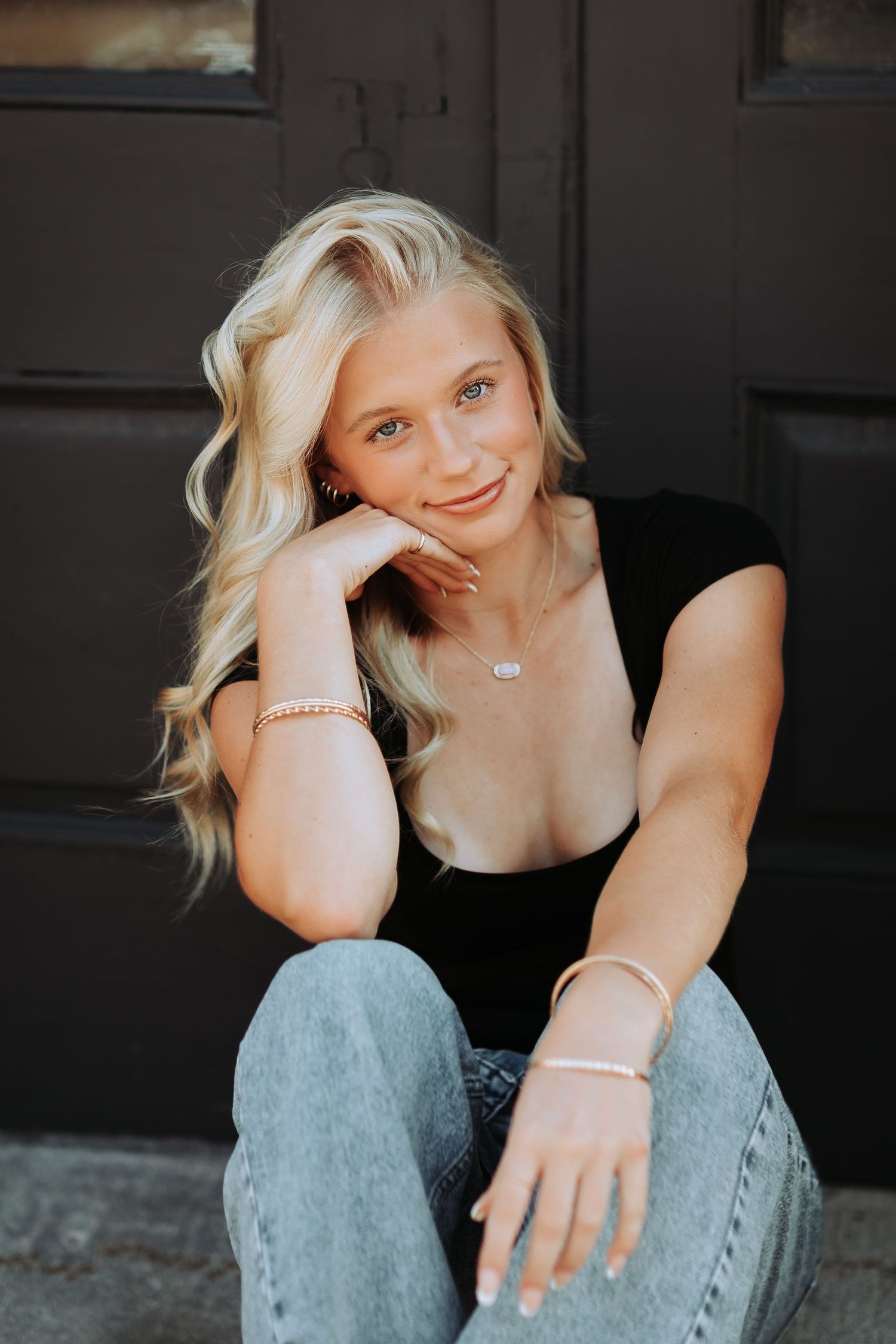 NH High School Senior Portrait photoshoot with natural lighting shows someone wearing a black top and distressed jeans in casual poses