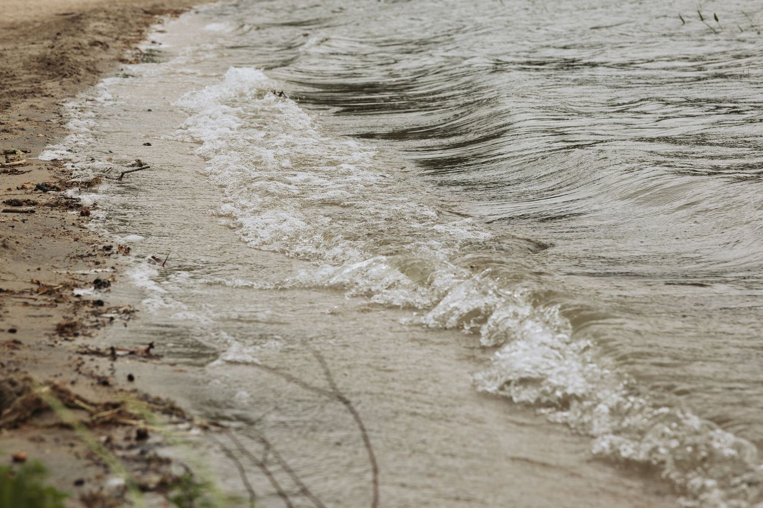 A series of rippling waves break gently along a shoreline with visible water movement patterns portsmouth nh