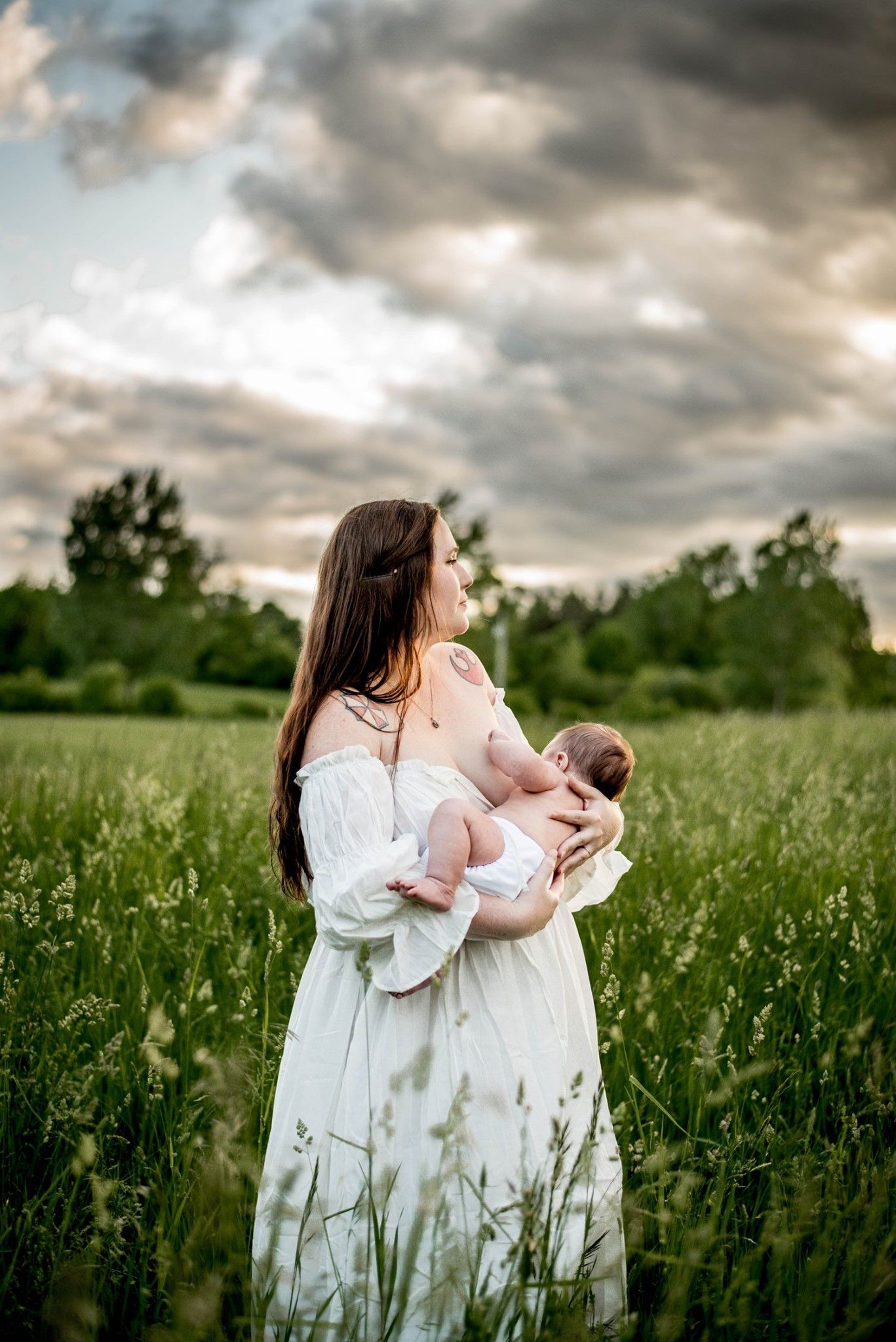 Ethereal scene in a wildflower meadow at sunset with flowing white dresses.