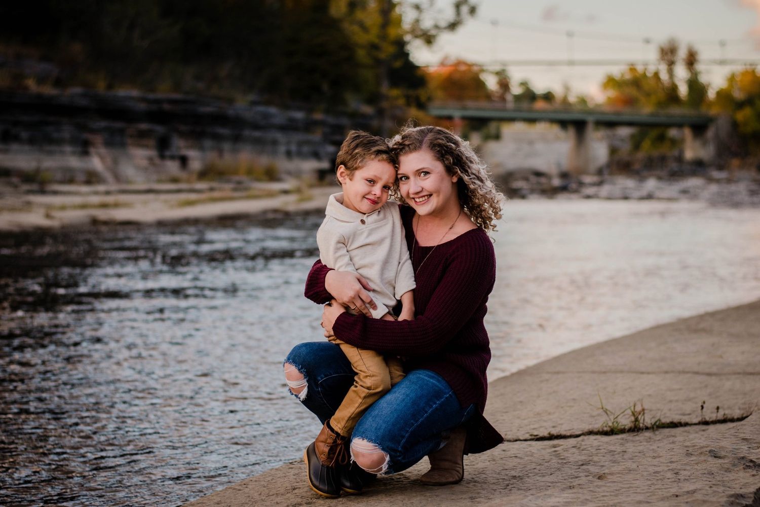Intimate family photos captured at sunset along rocky beach shoreline.