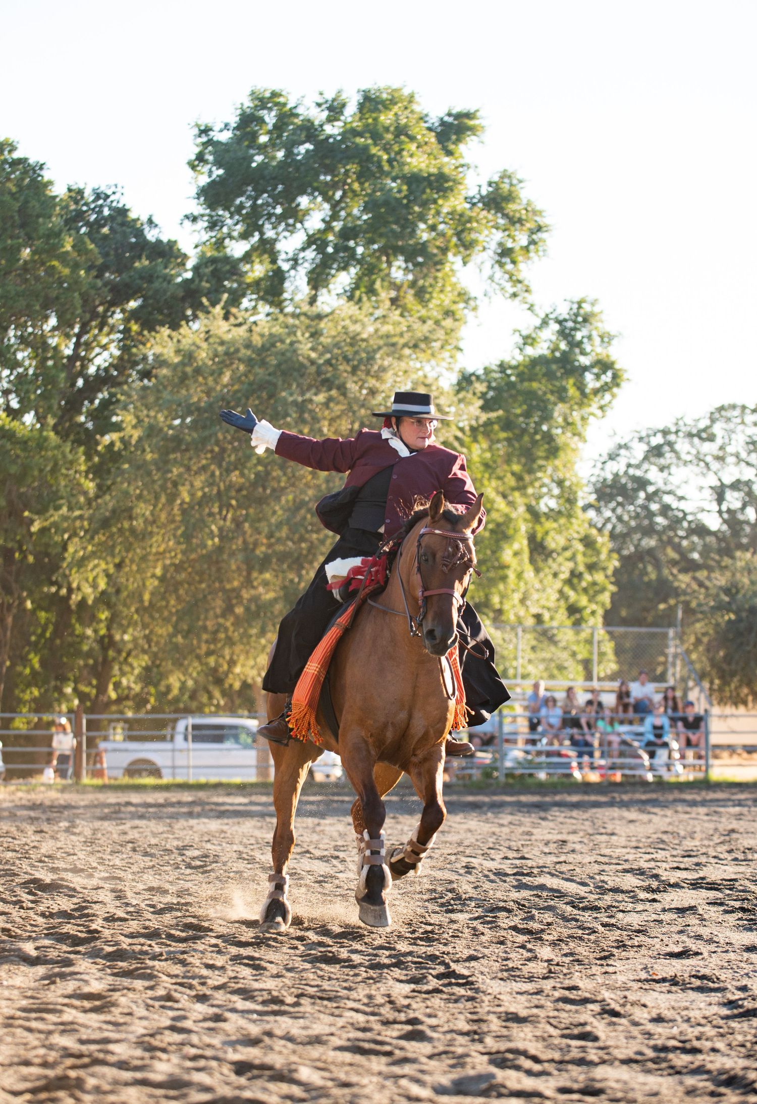 Action shots of riders performing stunts on horseback in a sandy arena.