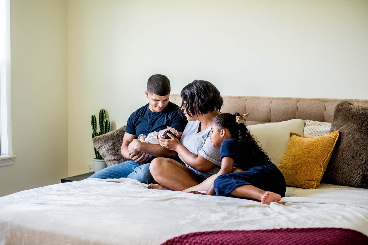 An intimate lifestyle scene on a cozy bed with decorative pillows and natural lighting.