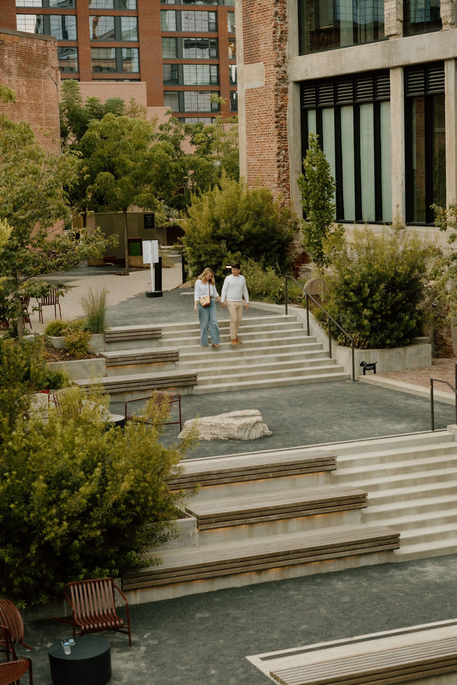 Modern urban architecture featuring concrete steps and benches with geometric lines.