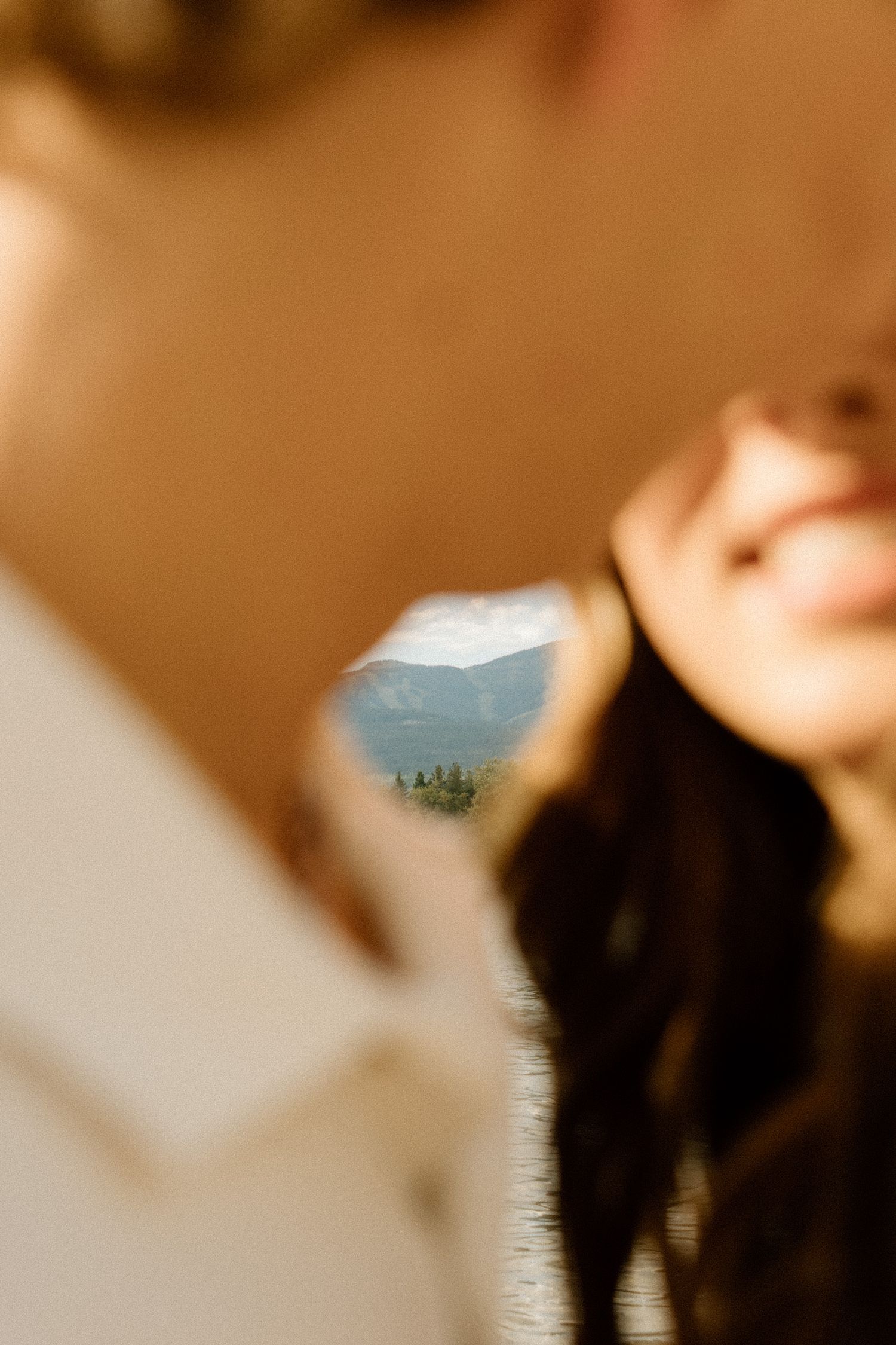 Scenic mountain lake view captured through a small window frame.