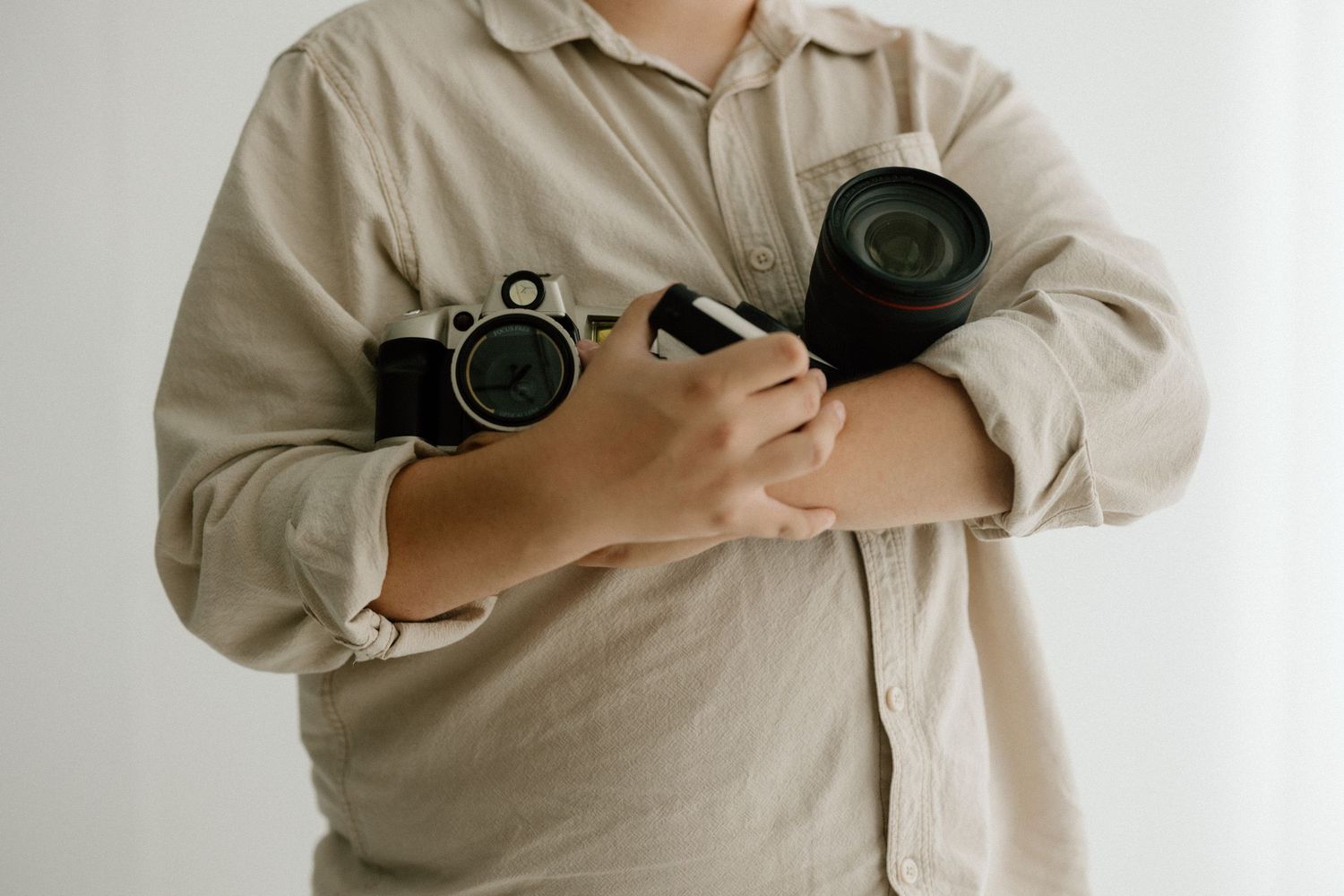 Camera equipment displayed in minimal setting with beige tones.