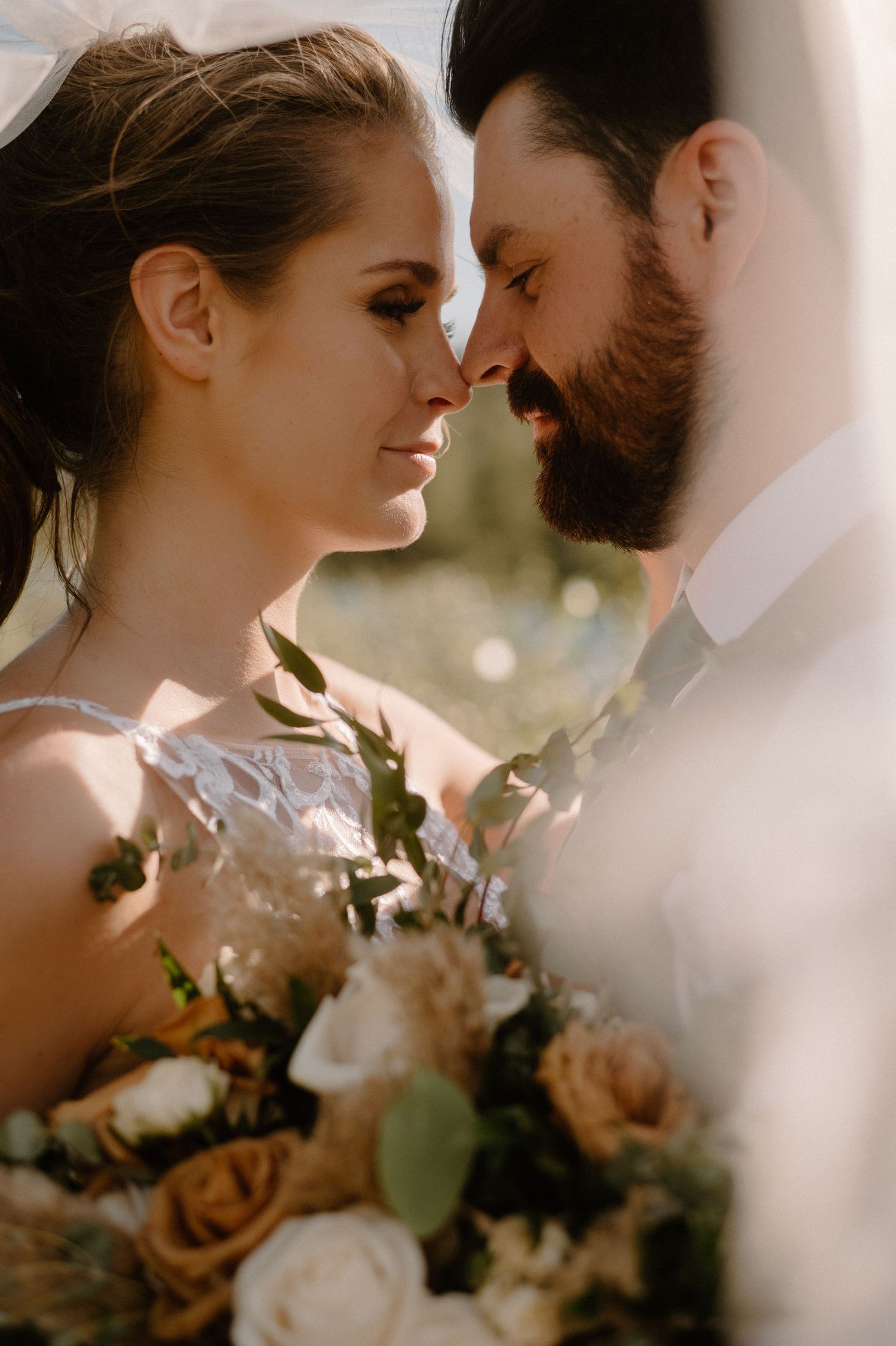 Close up of bride and groom in sunlight