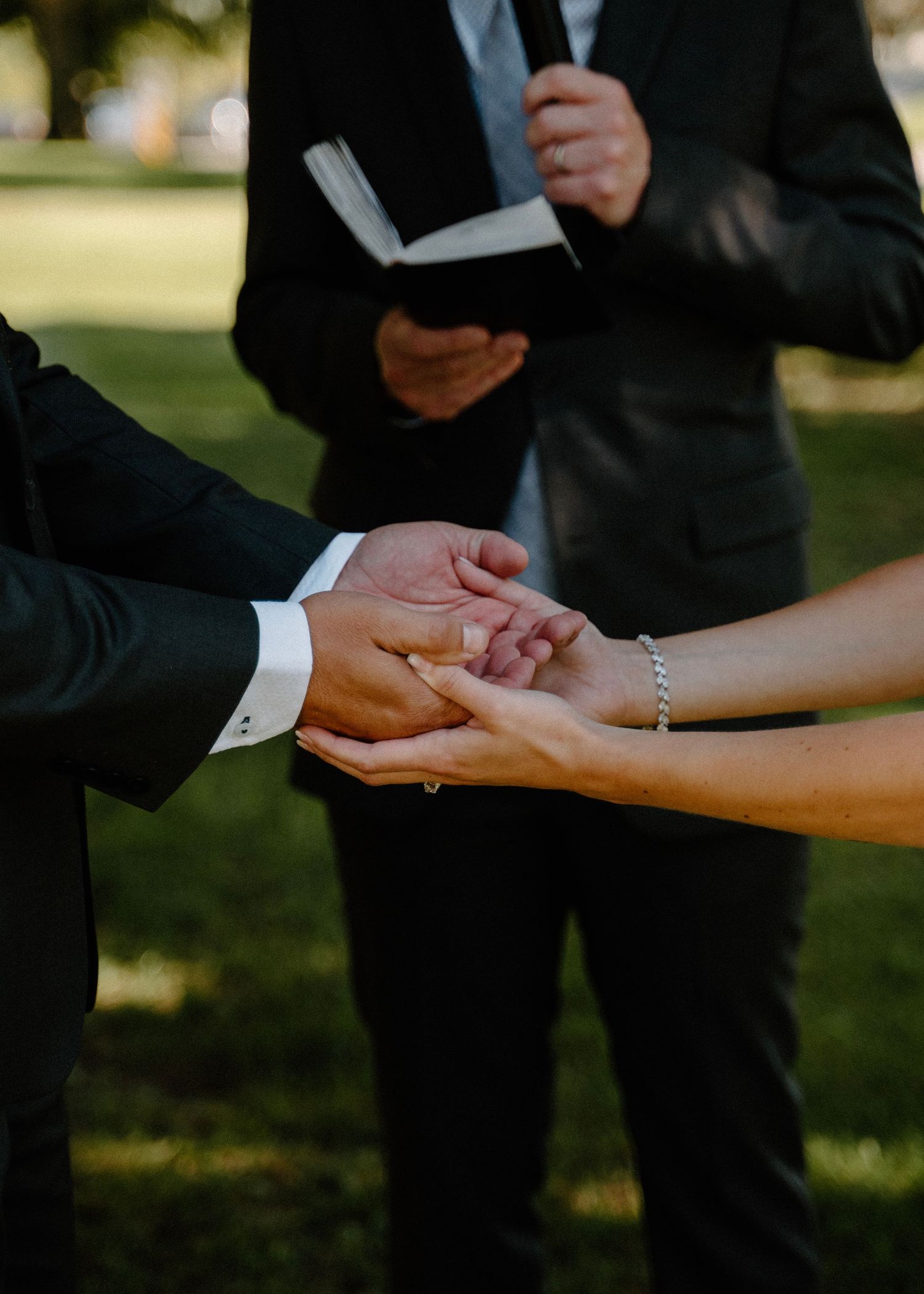 Couples hands holding at the altar