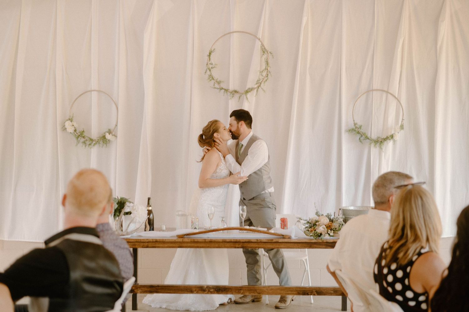 Bride and groom kissing at reception