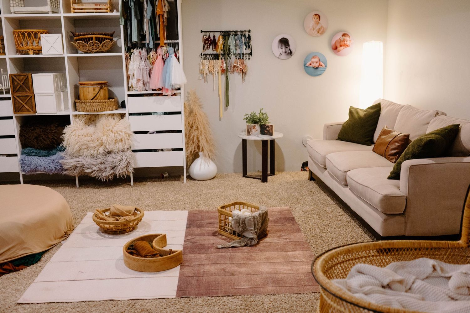 Boho Leduc photography studio with props, white shelving, beige sofa, layered rugs, and wicker accents.