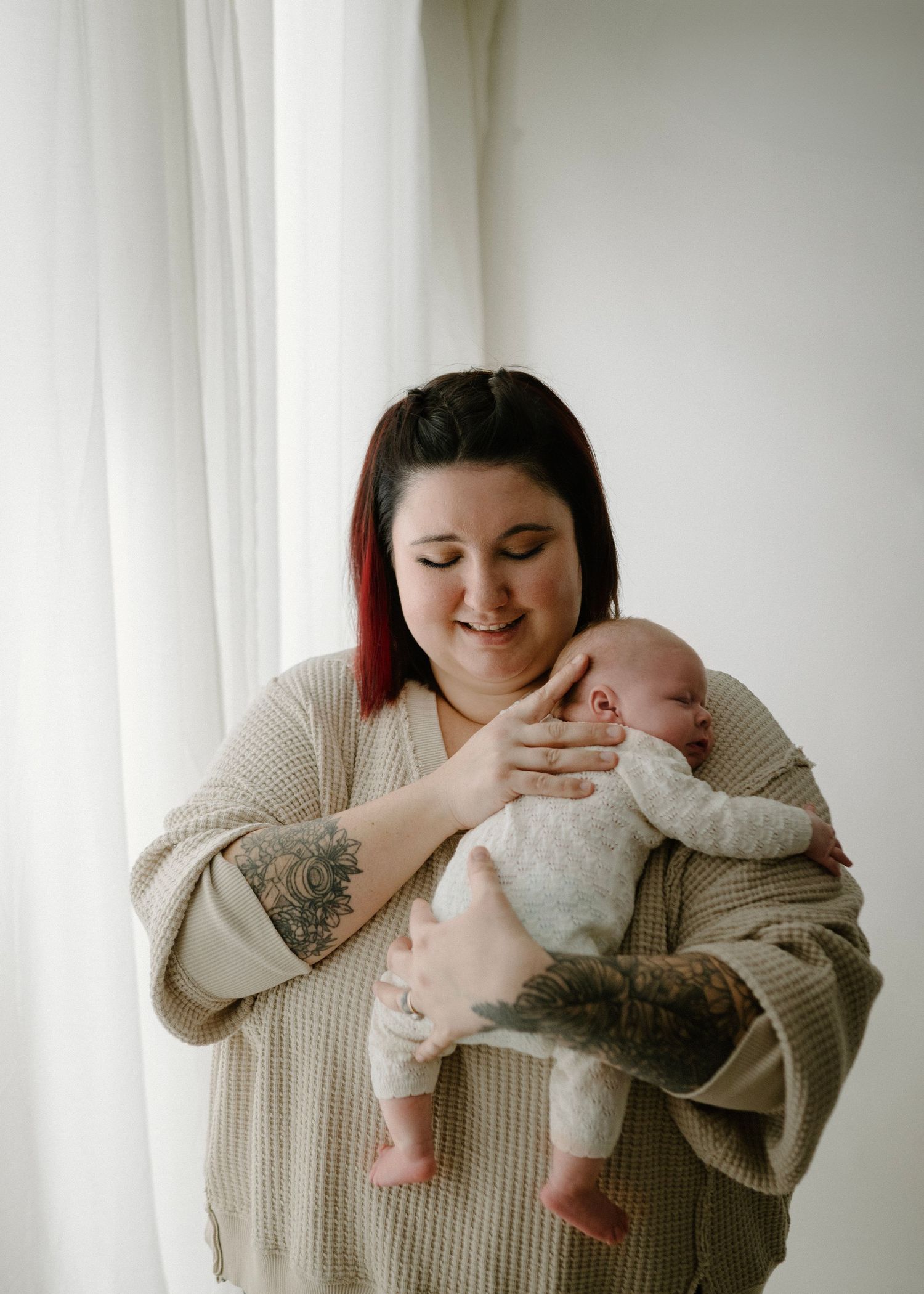 Newborn Photographer soothing a baby in her Bright Leduc Studio.