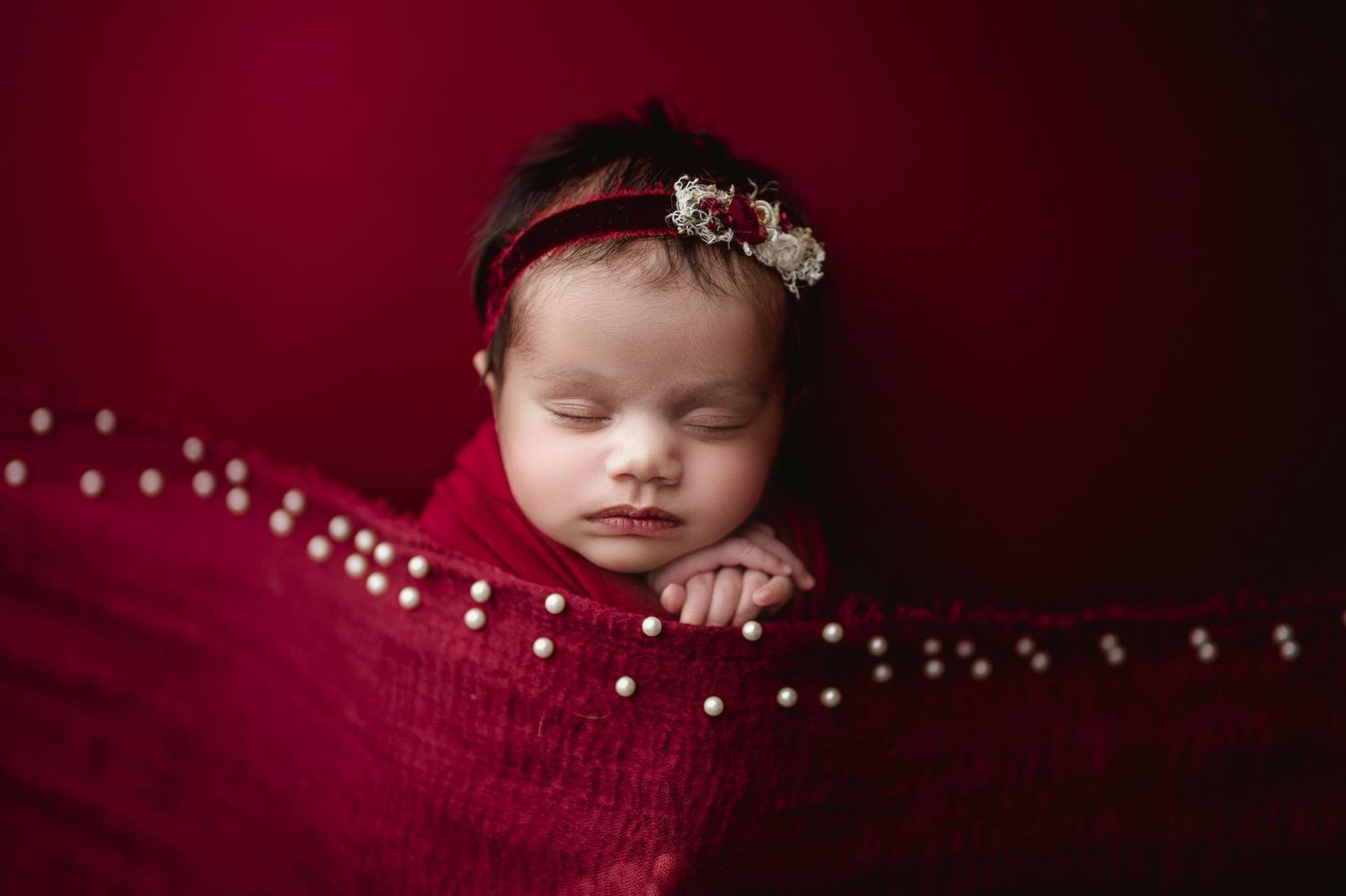 Newborn Baby in red Leduc Alberta photographer